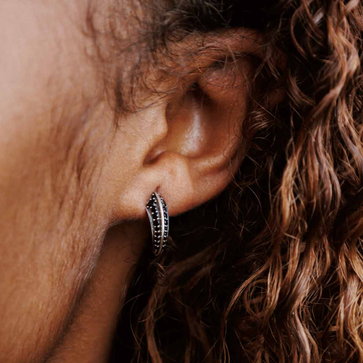 model wearing Astral Talon Earrings