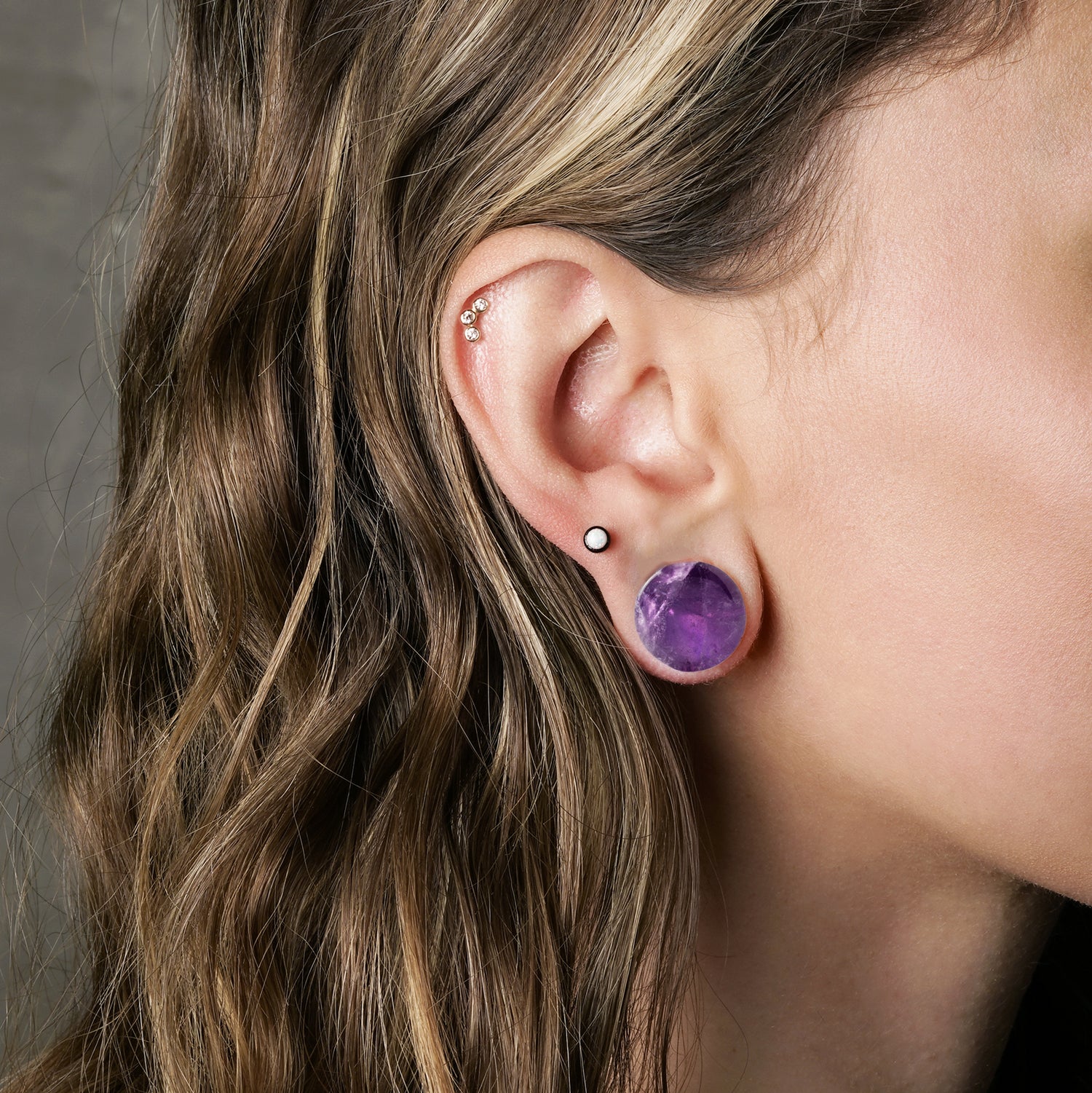 model wearing Amethyst Plugs