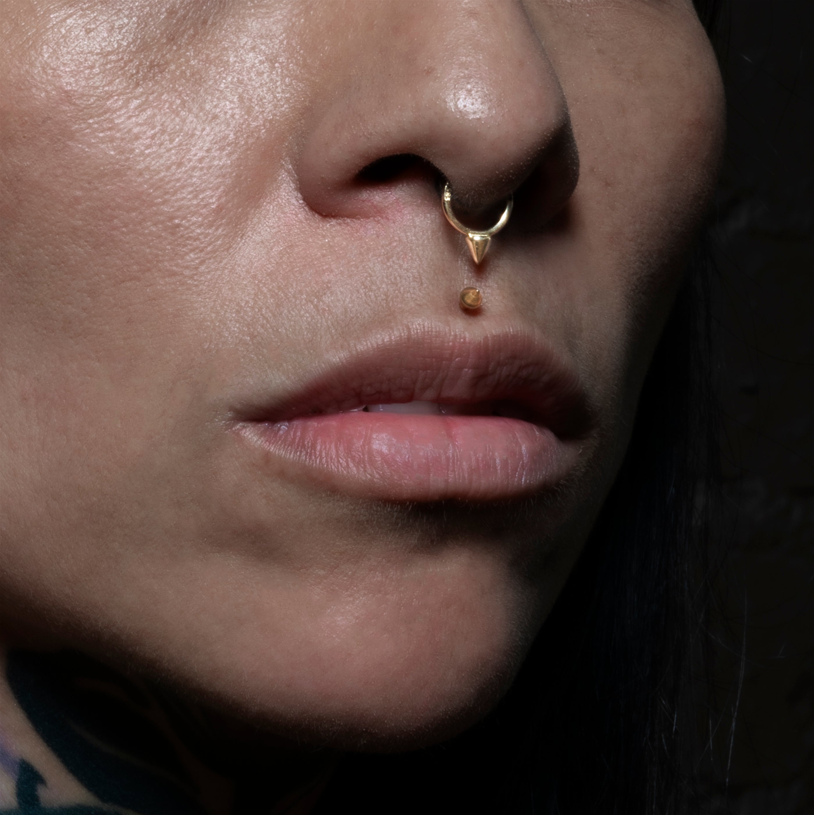 model wearinb 14k Gold Spike Clicker Ring on her septum