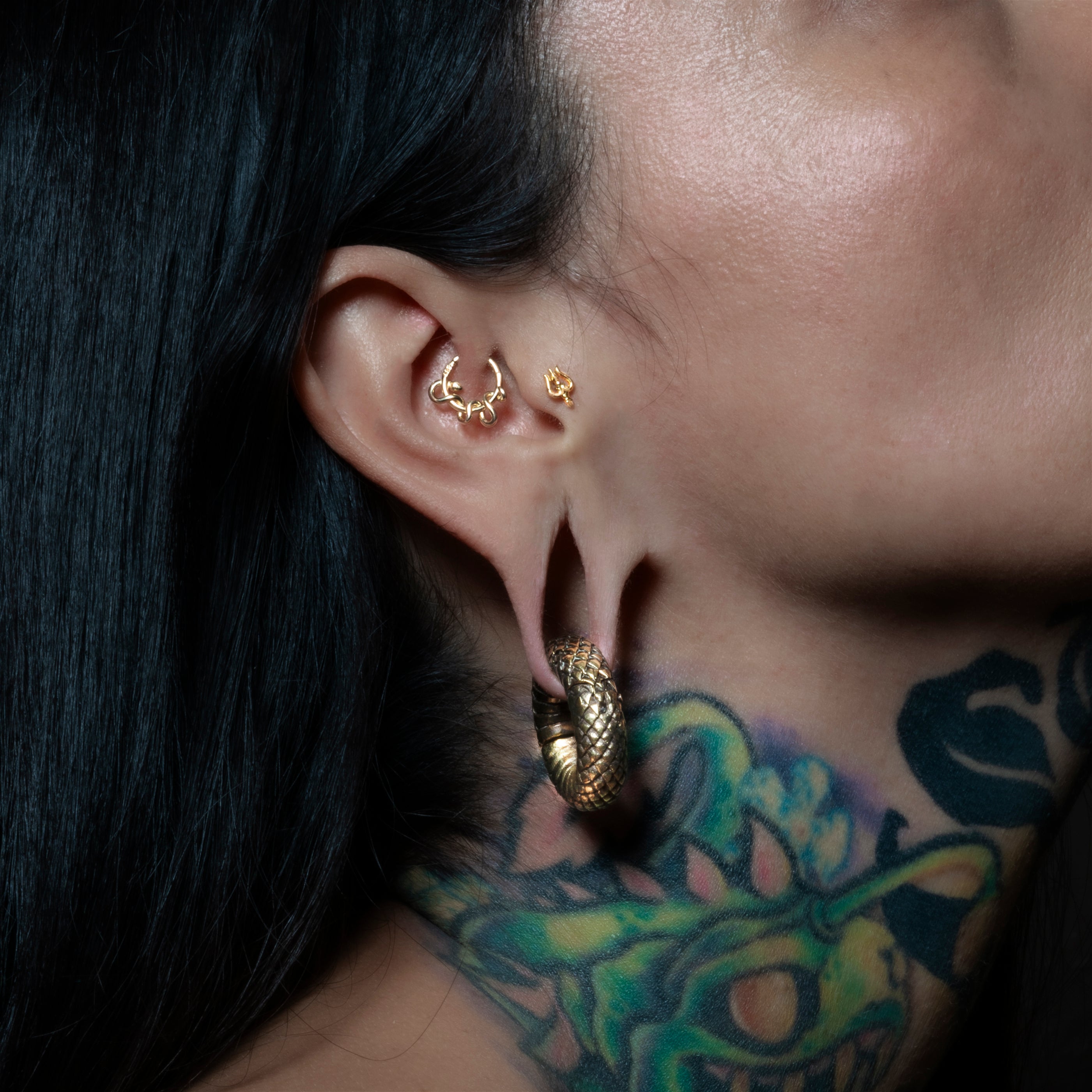 model wearing 14k Gold Serpent Clicker Ring on her daith