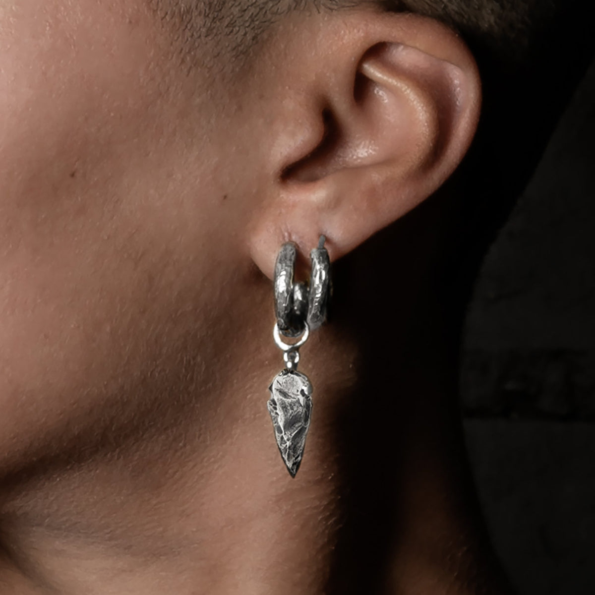 model wearing Arrowhead Silver Clicker Earrings