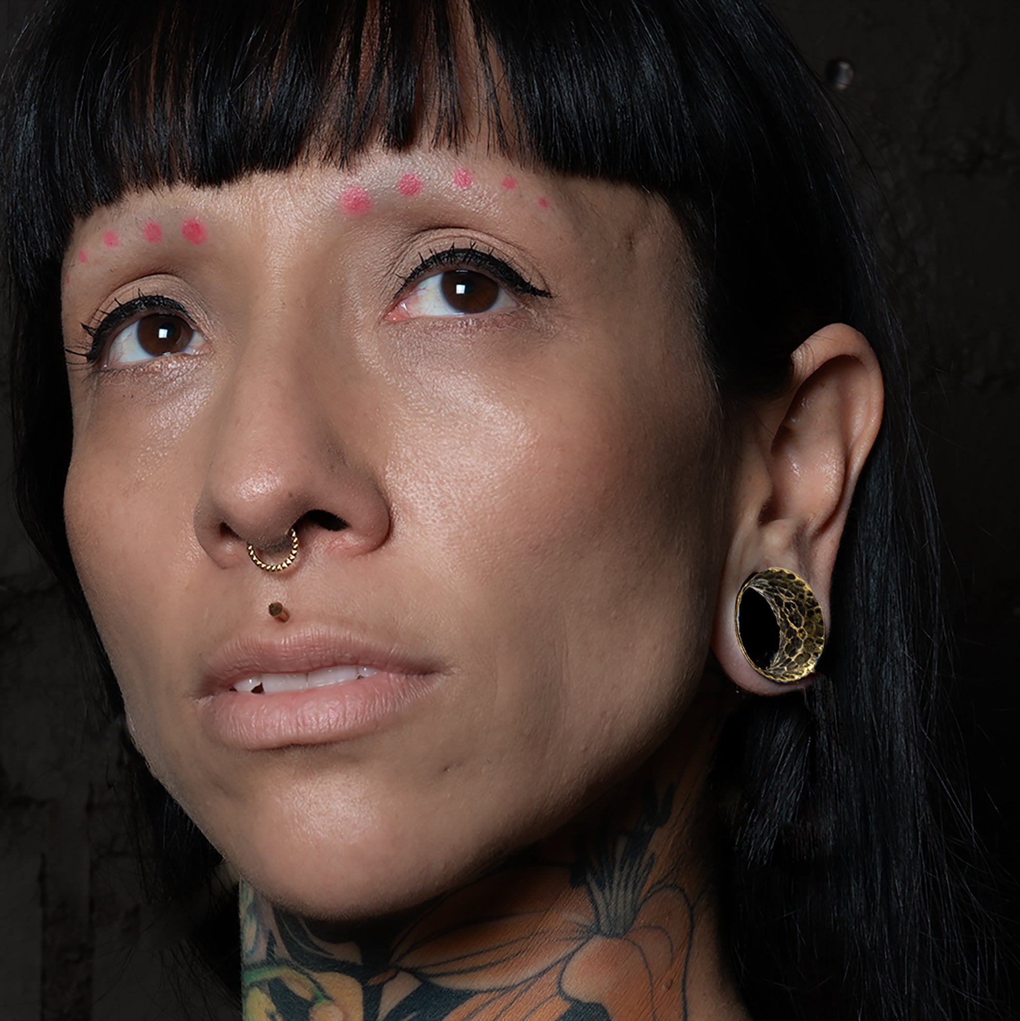 model wearing Hammered Brass Tunnels