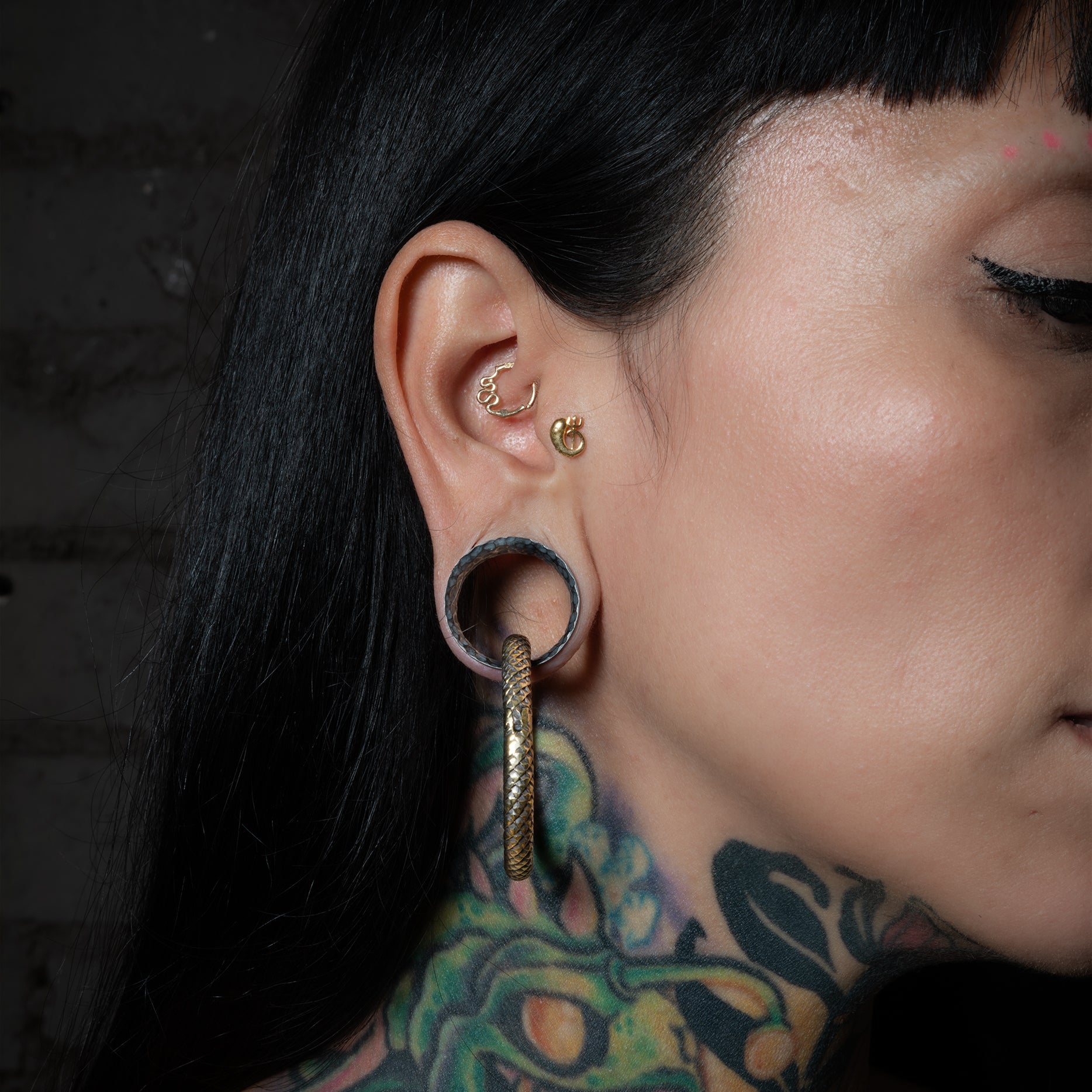 model wearing 14k Gold Snake Clicker Ring on her daith piercing