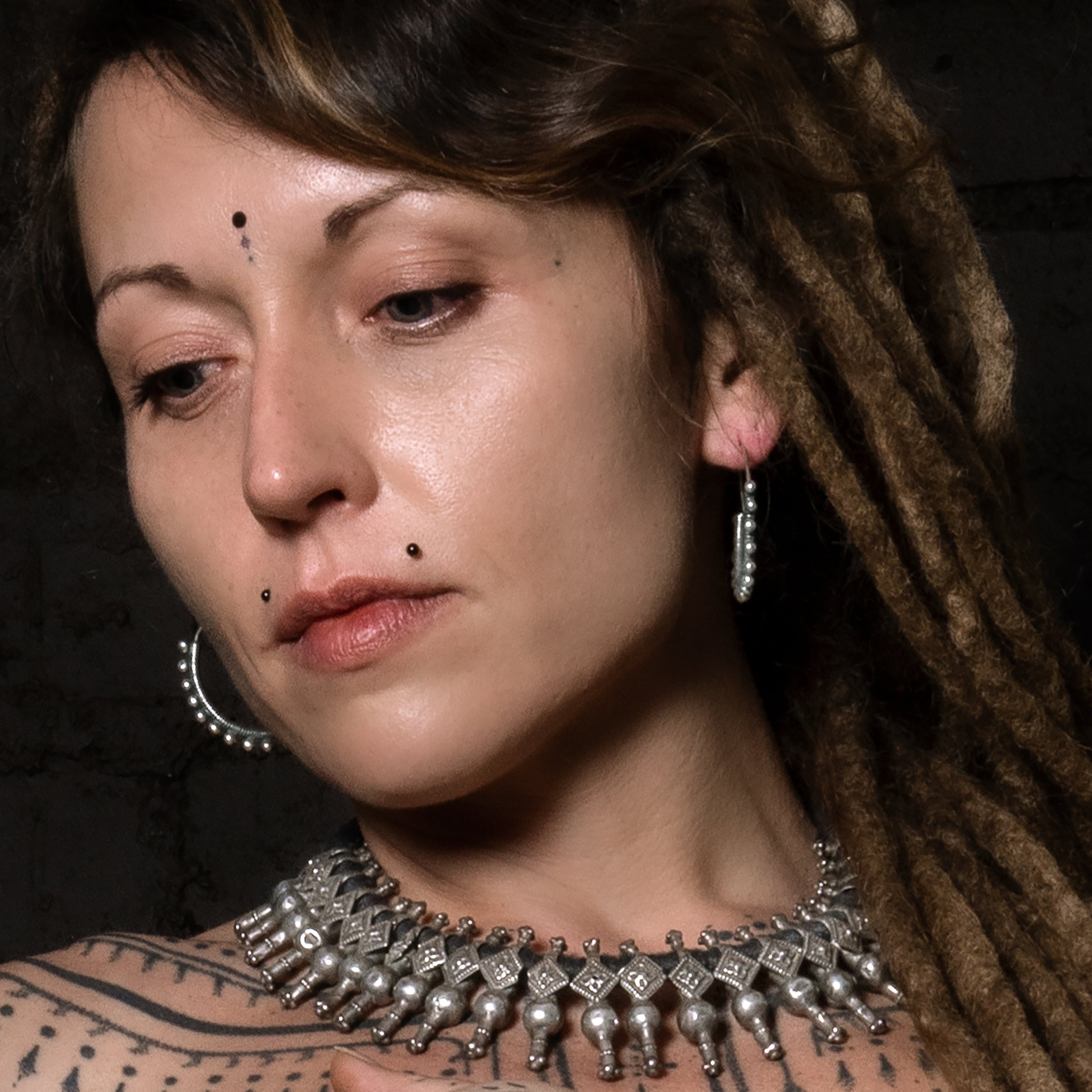 model wearing  Silver Spheres Hoop Earrings