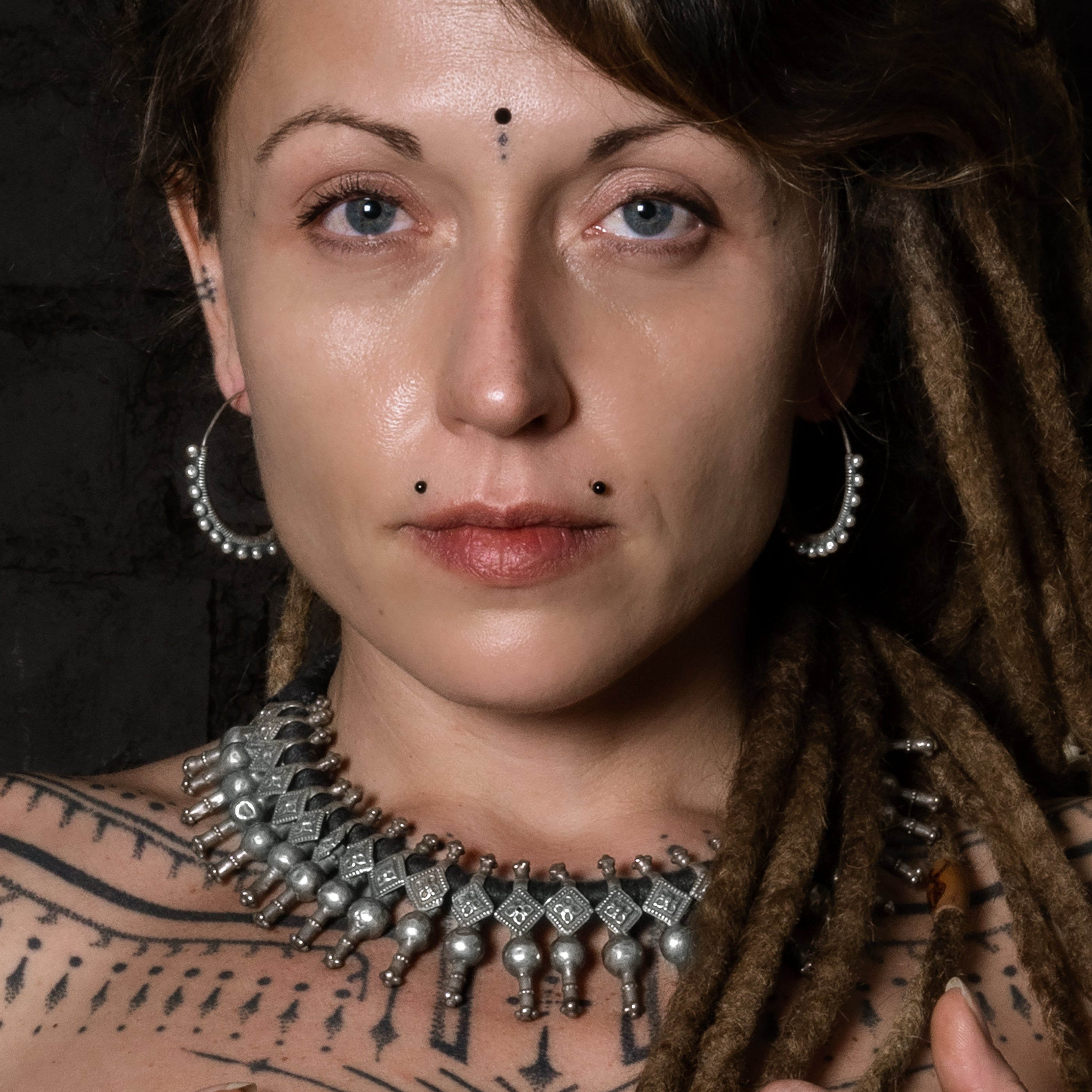 model wearing  Silver Spheres Hoop Earrings