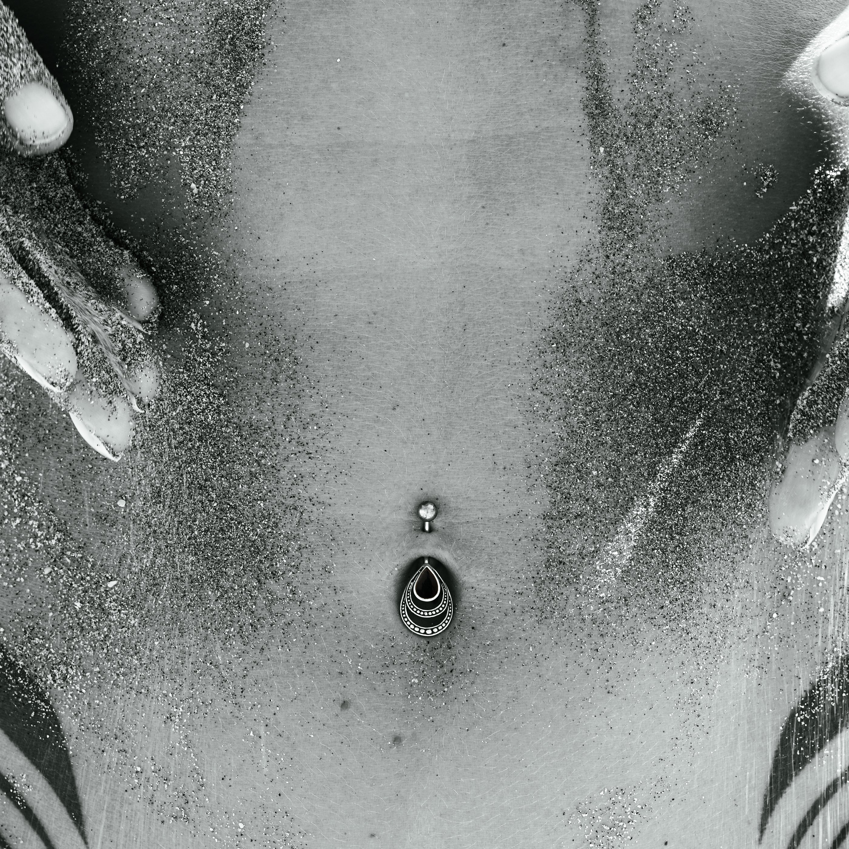 model wearing Silver Drop Onyx Belly Piercing