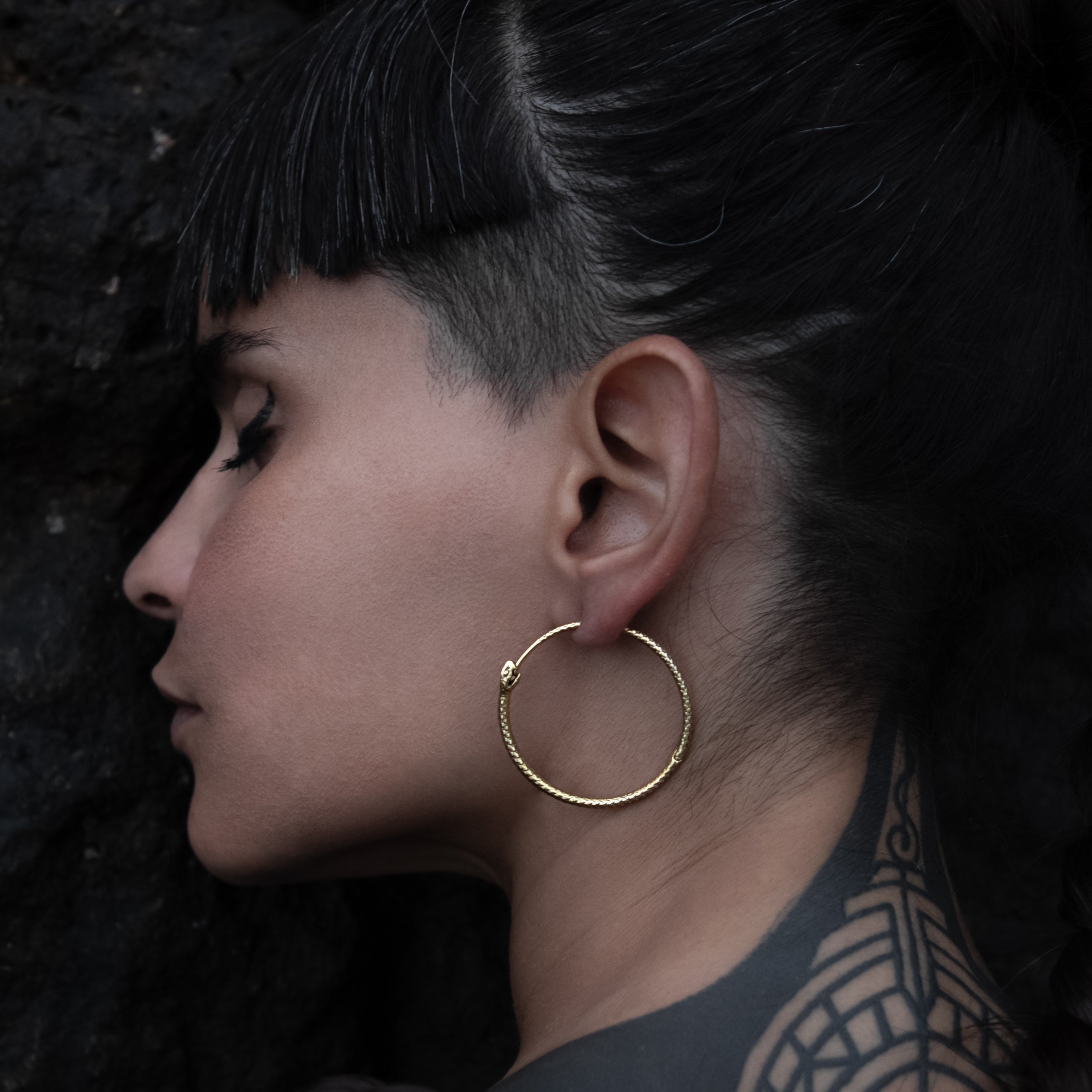 model wearing Ouroboros Hoop Earrings