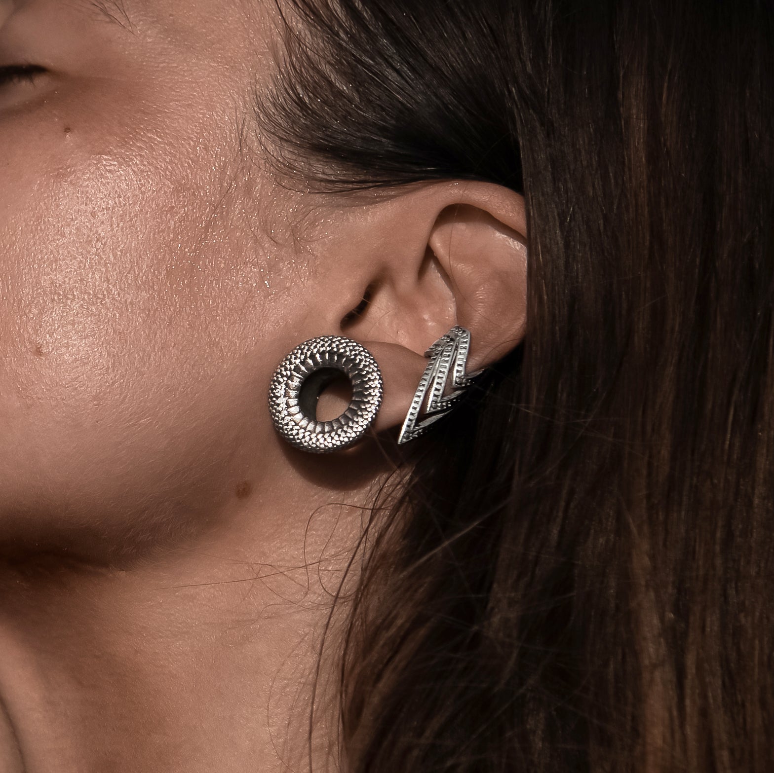 model with Rebirth Silver Ear Tunnels