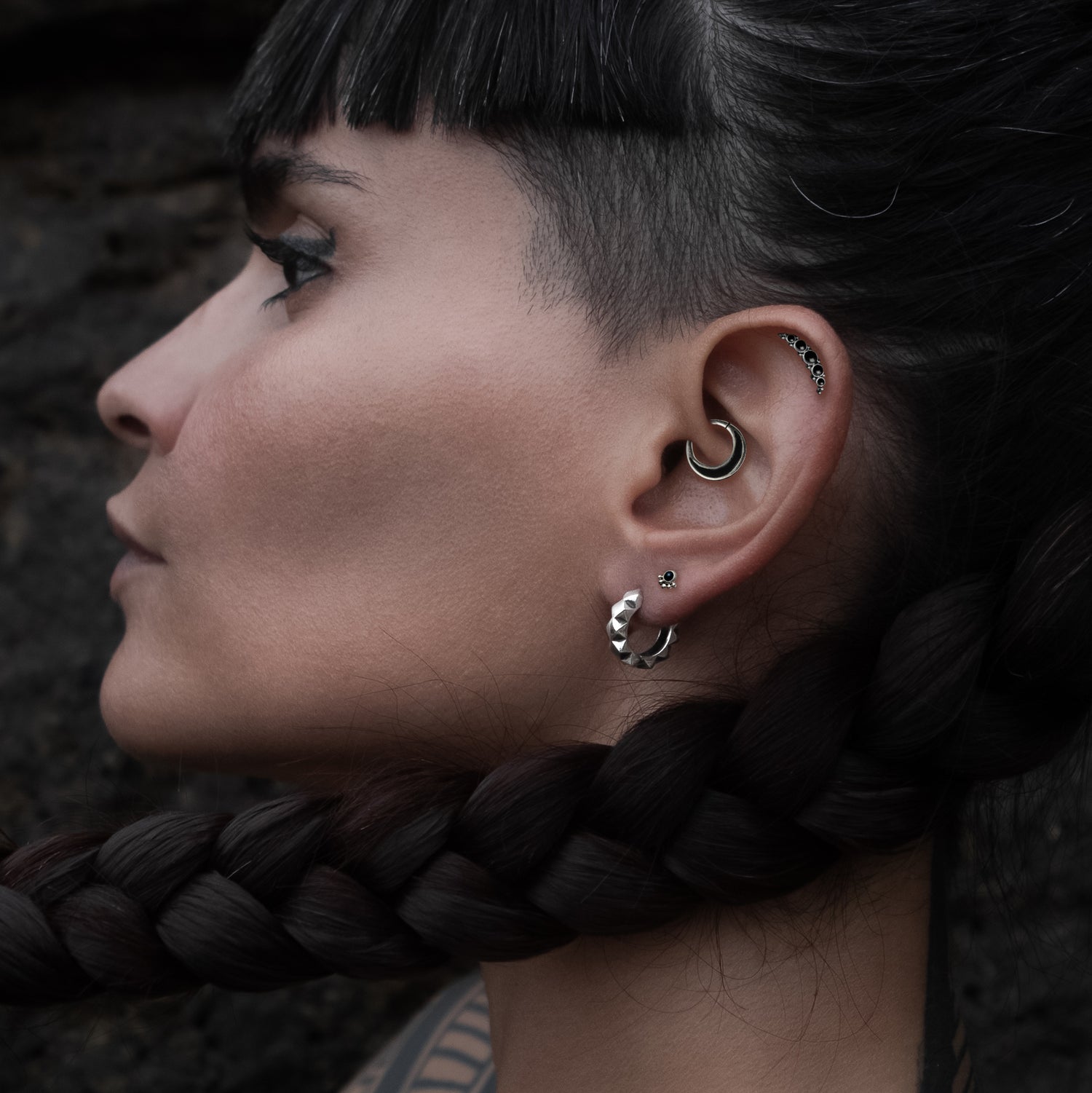 model wearing Layla Labret with Onyx on her upper lobe Aanya Black Shell Silver Septum piercing ring on her daith and Quintuple Onyx Deva Labret on her helix