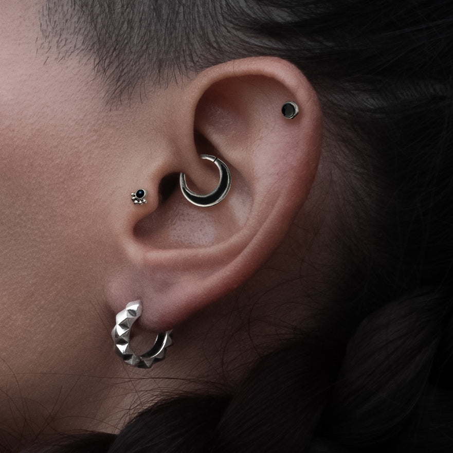 model wearing Titanium Labret with Black Onyx on her helix