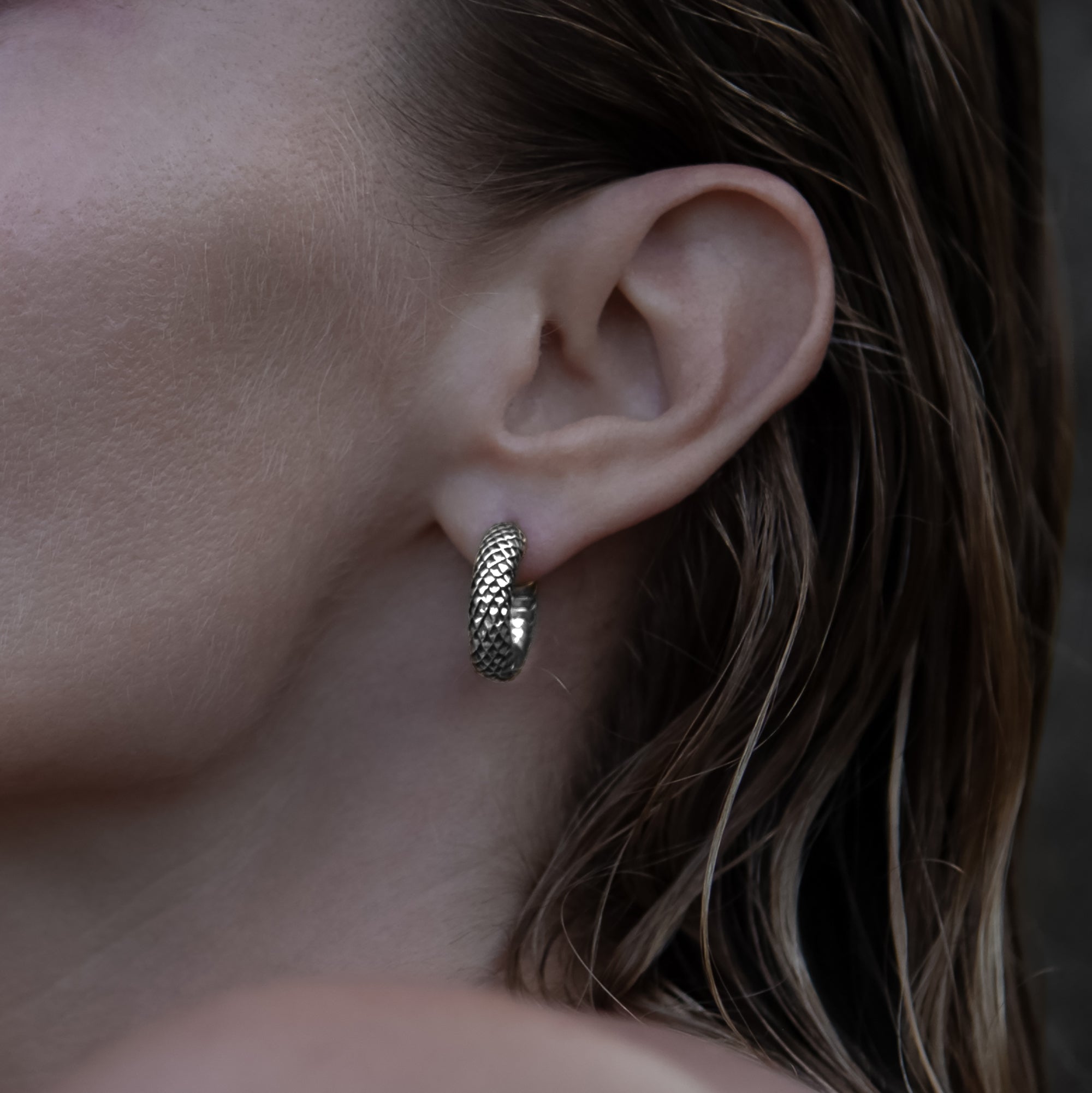 model wearing Rebirth Silver Clicker Earrings