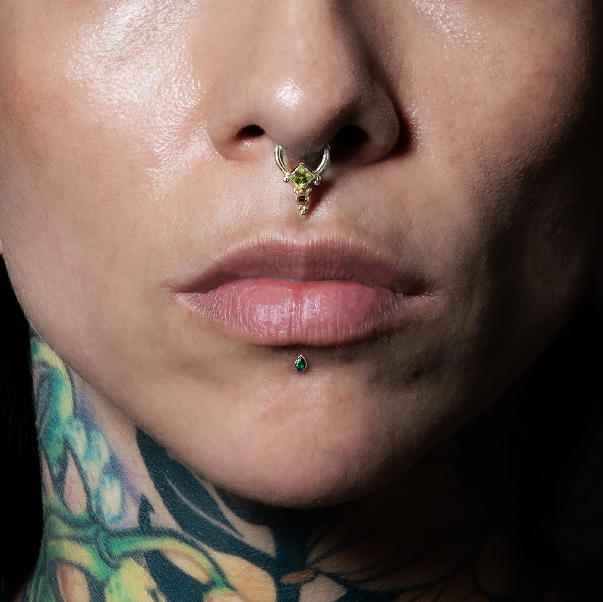 model wearing 14k Gold Green CZ Teardrop Labret on her lower lip and Rishi Gold Septum - Peridot and Smokey Quartz