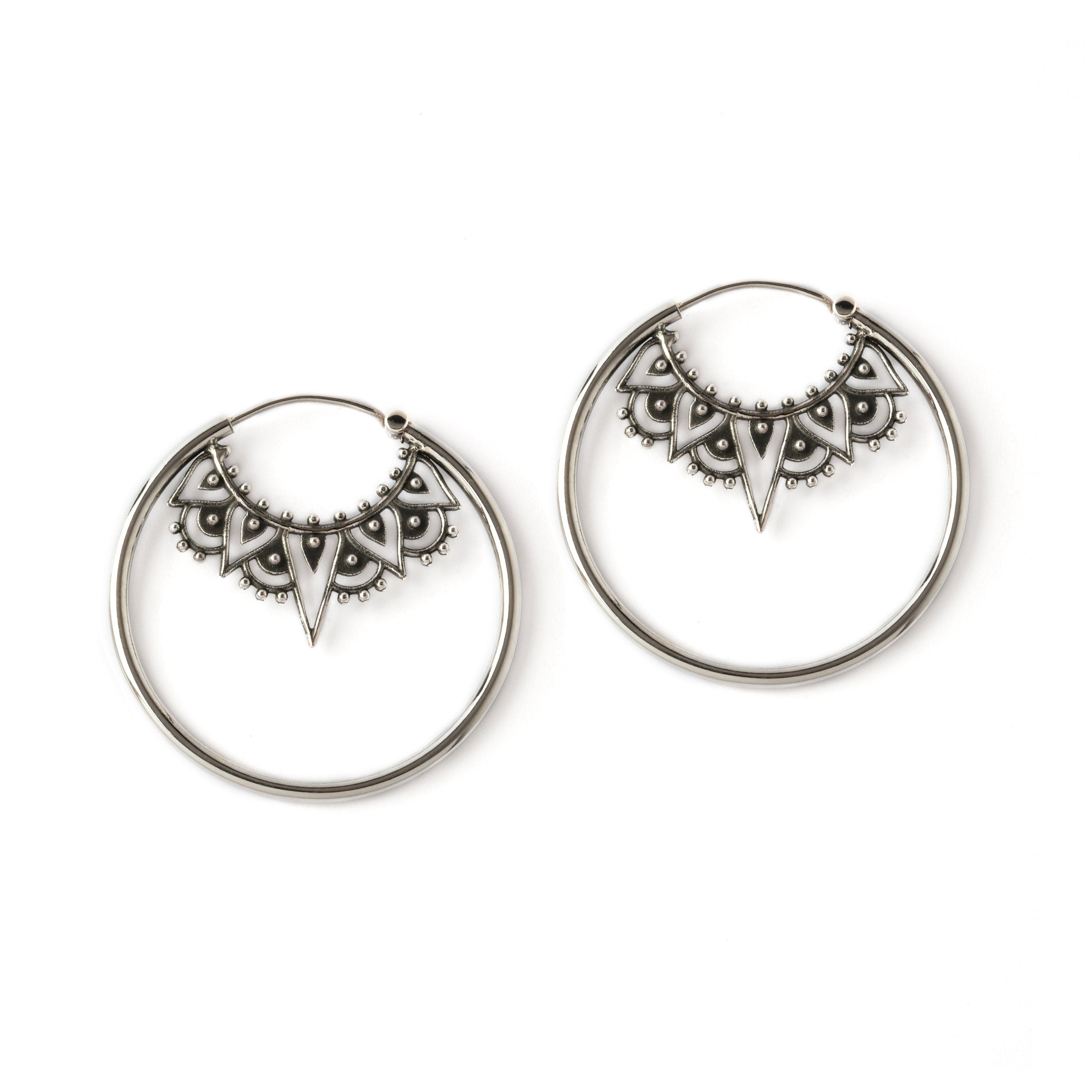 sterling silver large hoop earrings framing an ethnic filigree collar ornament frontal view