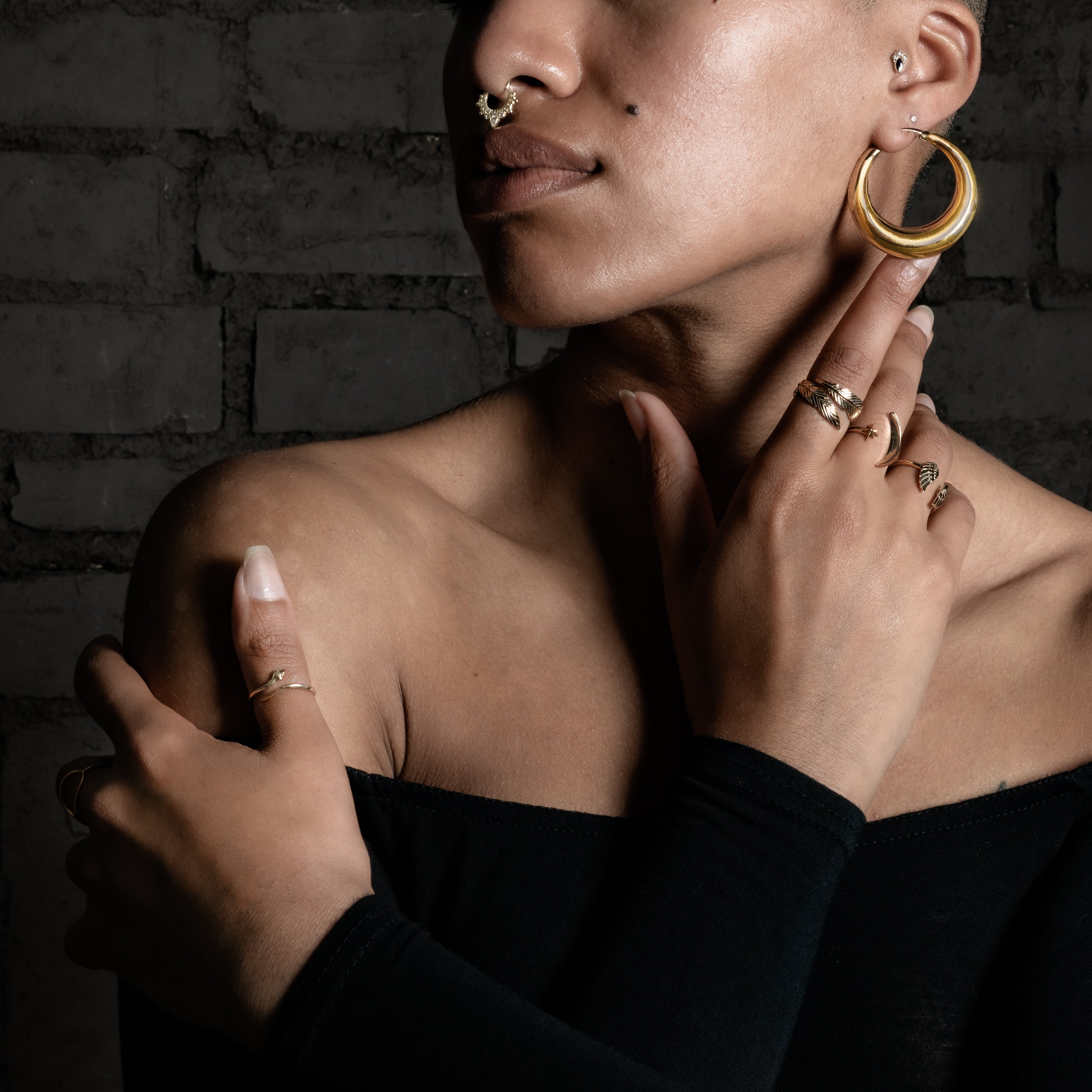 model wearing Open Feather Bronze Ring, Celestial ring, Wings ring and snake ring
