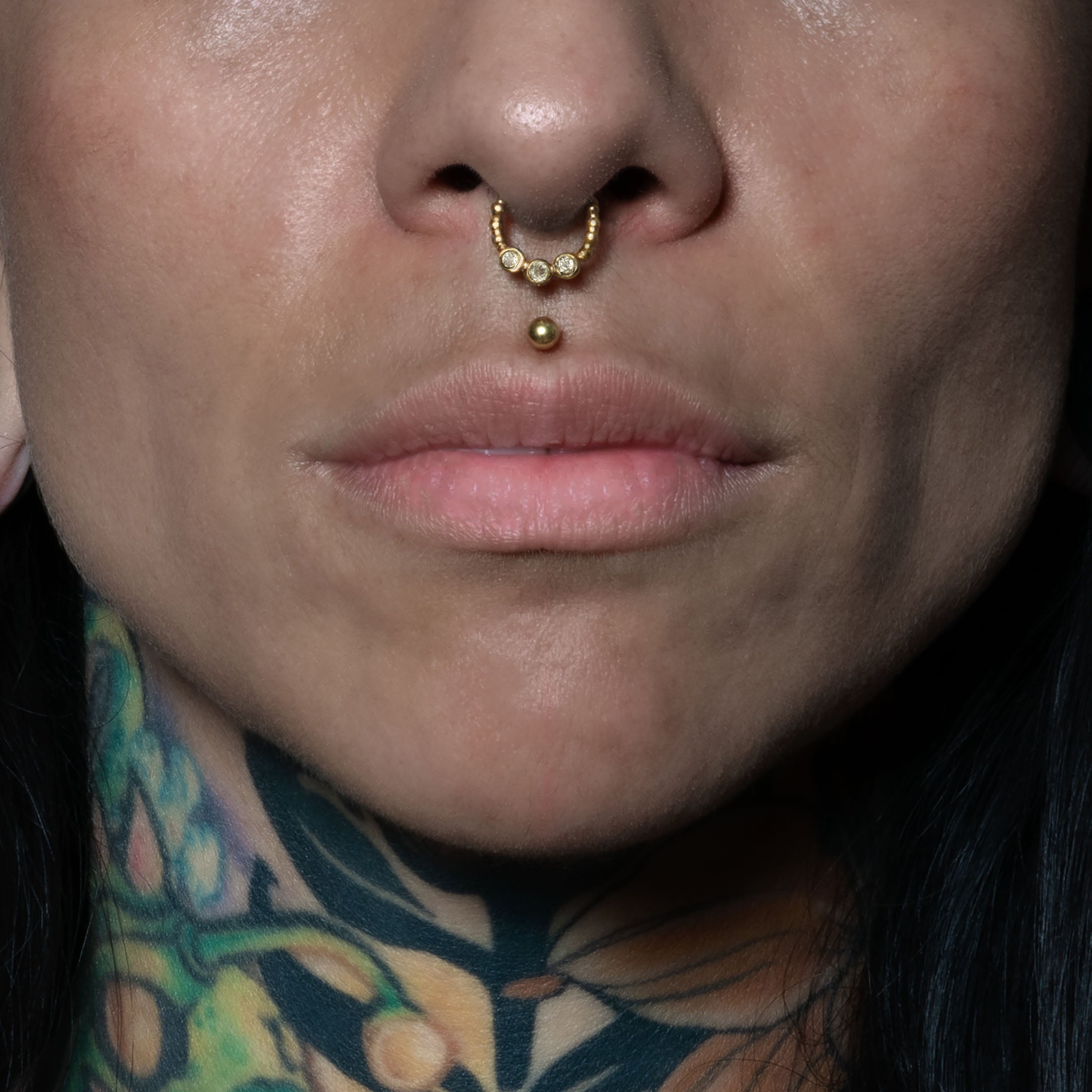 model wearing Trio White Topaz Gold Septum