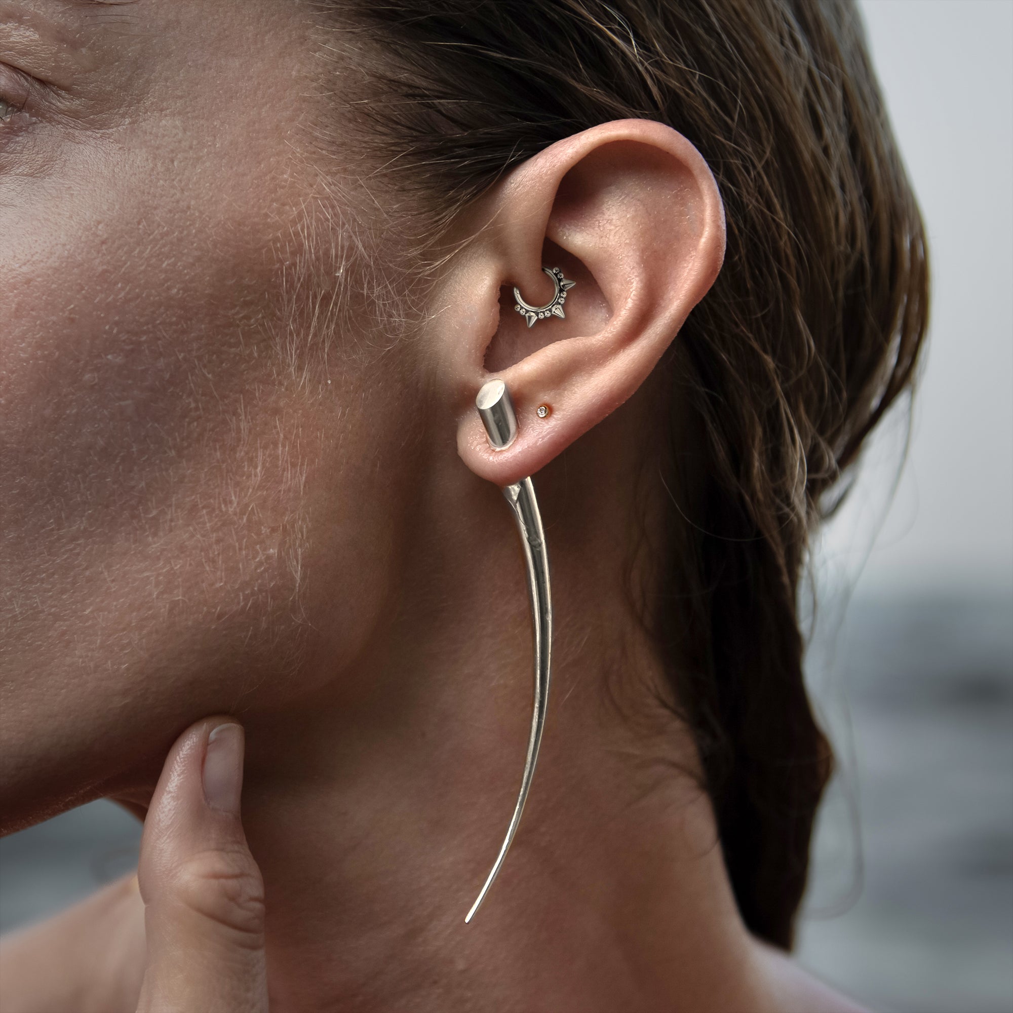 model wearing Spiky Septum Clicker on her daith