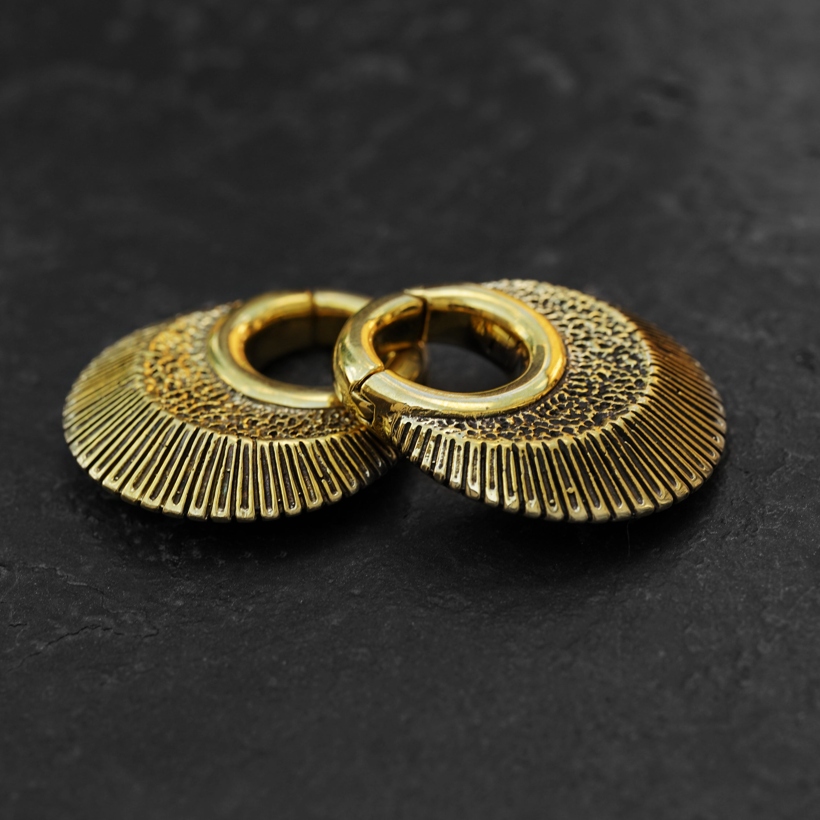 Brass African clicker Hoop Gauge Earrings ear weights hangers black background