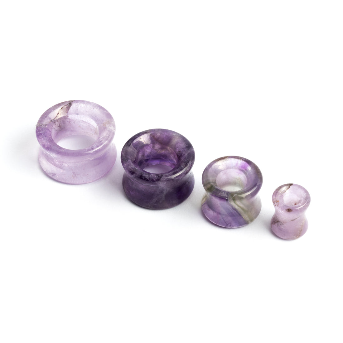 several sizes of Amethyst double flare stone ear tunnel frontal view