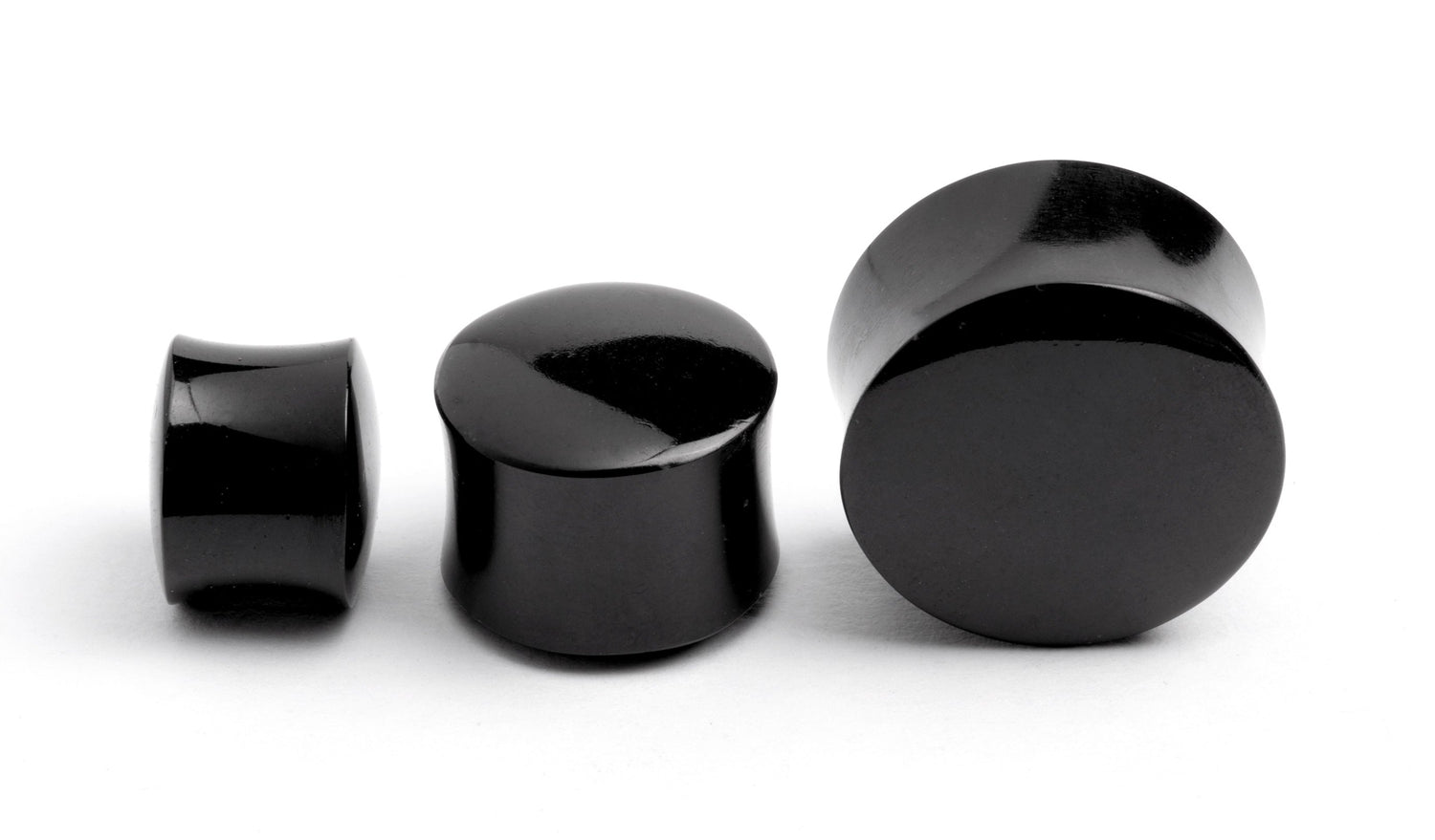 several sizes of black agate ear plugs