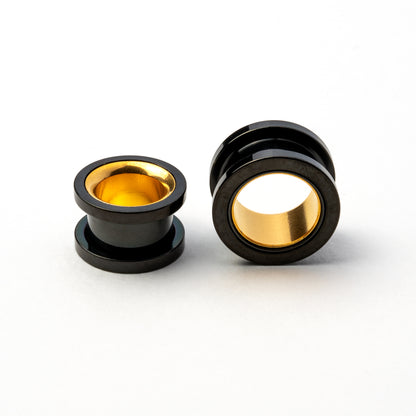 two black and gold surgical steel ear tunnels side and front view