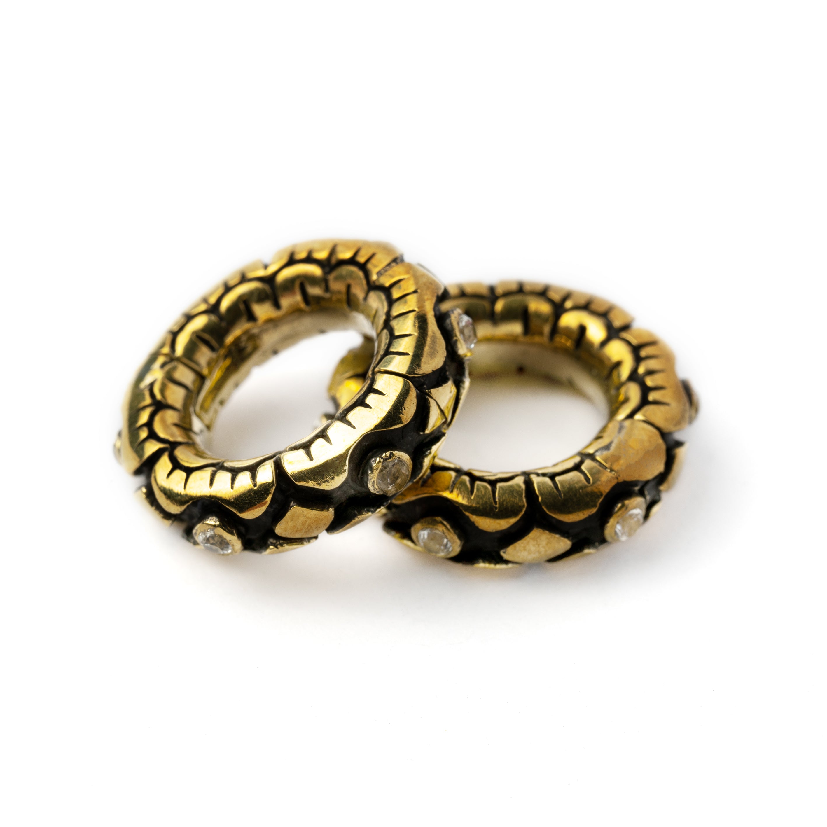 pair of golden flower clicker hoops hangers for stretched ears with topaz stones