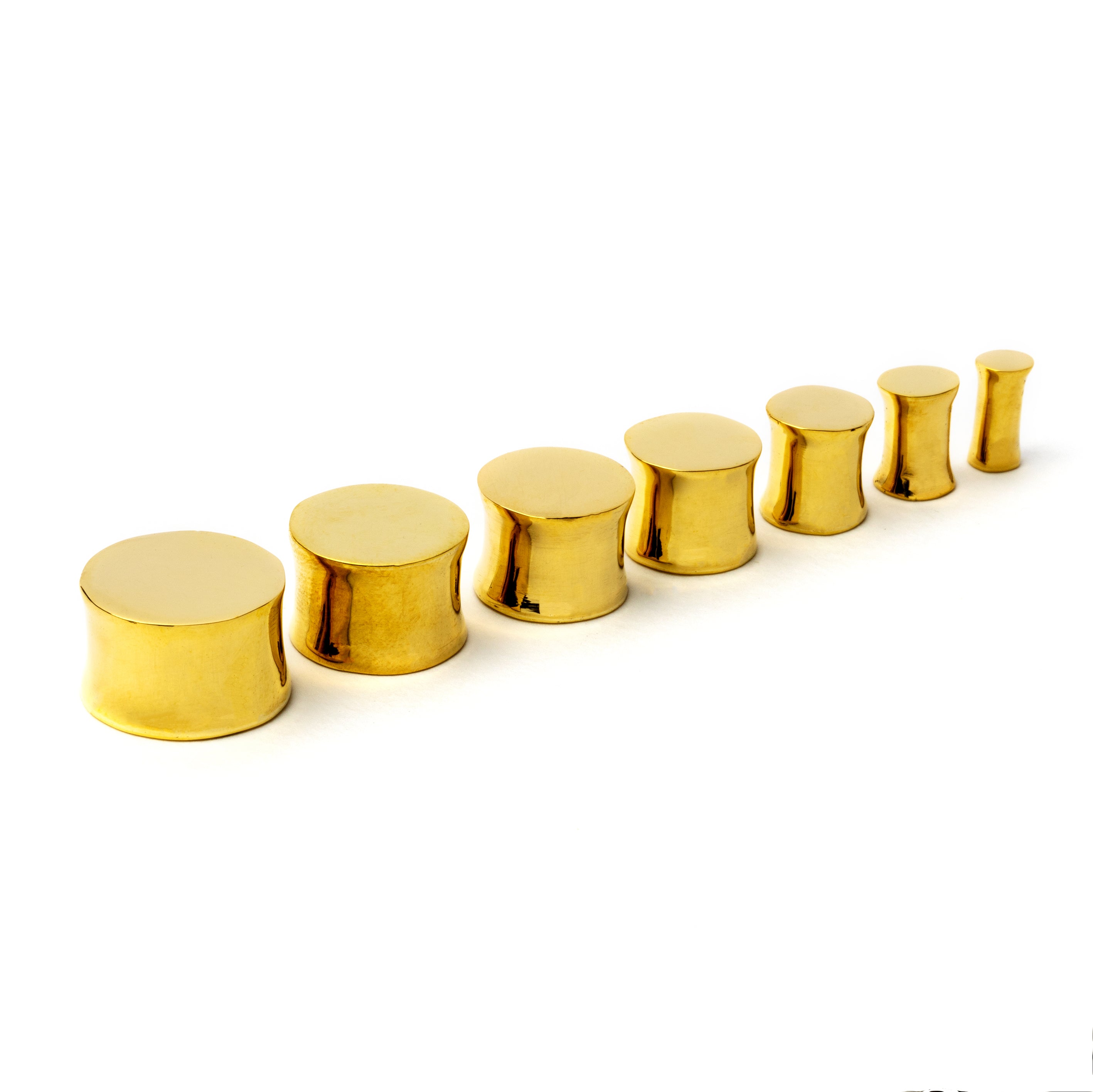 multiple sizes of golden brass plain plug earrings