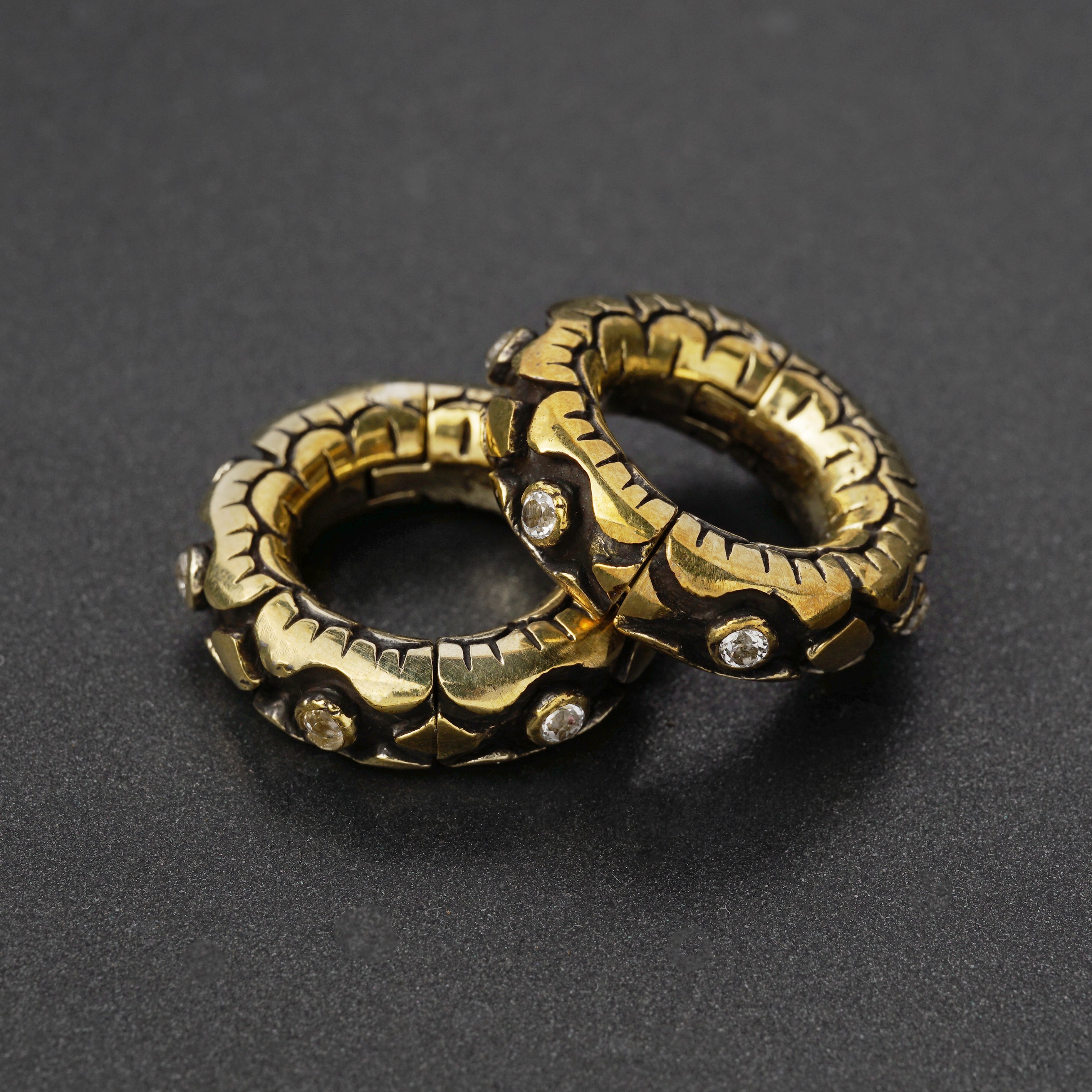 pair of golden clicker hoops ear weights hangers with carved petals and topaz gems