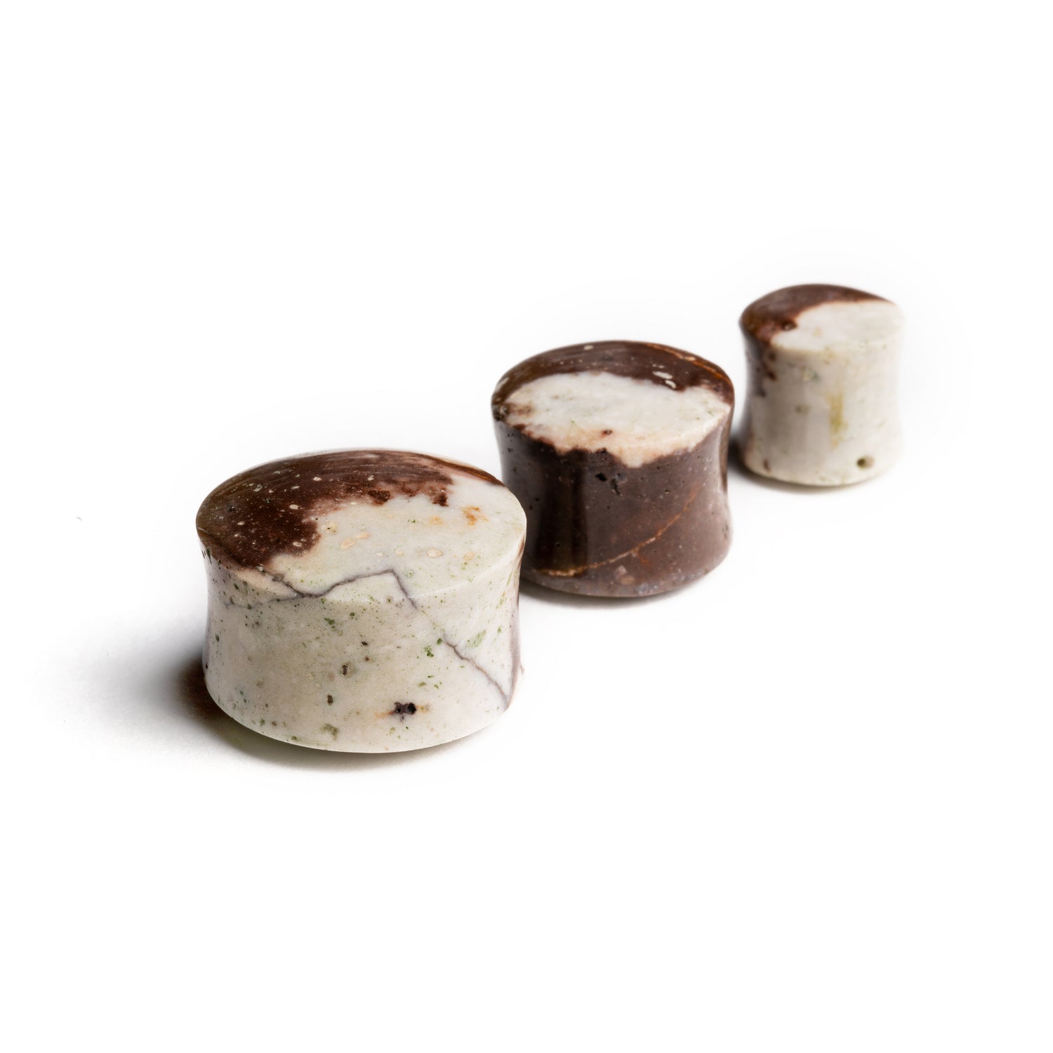 several sizes of Chocolate Jasper stone double flare ear plugs side view