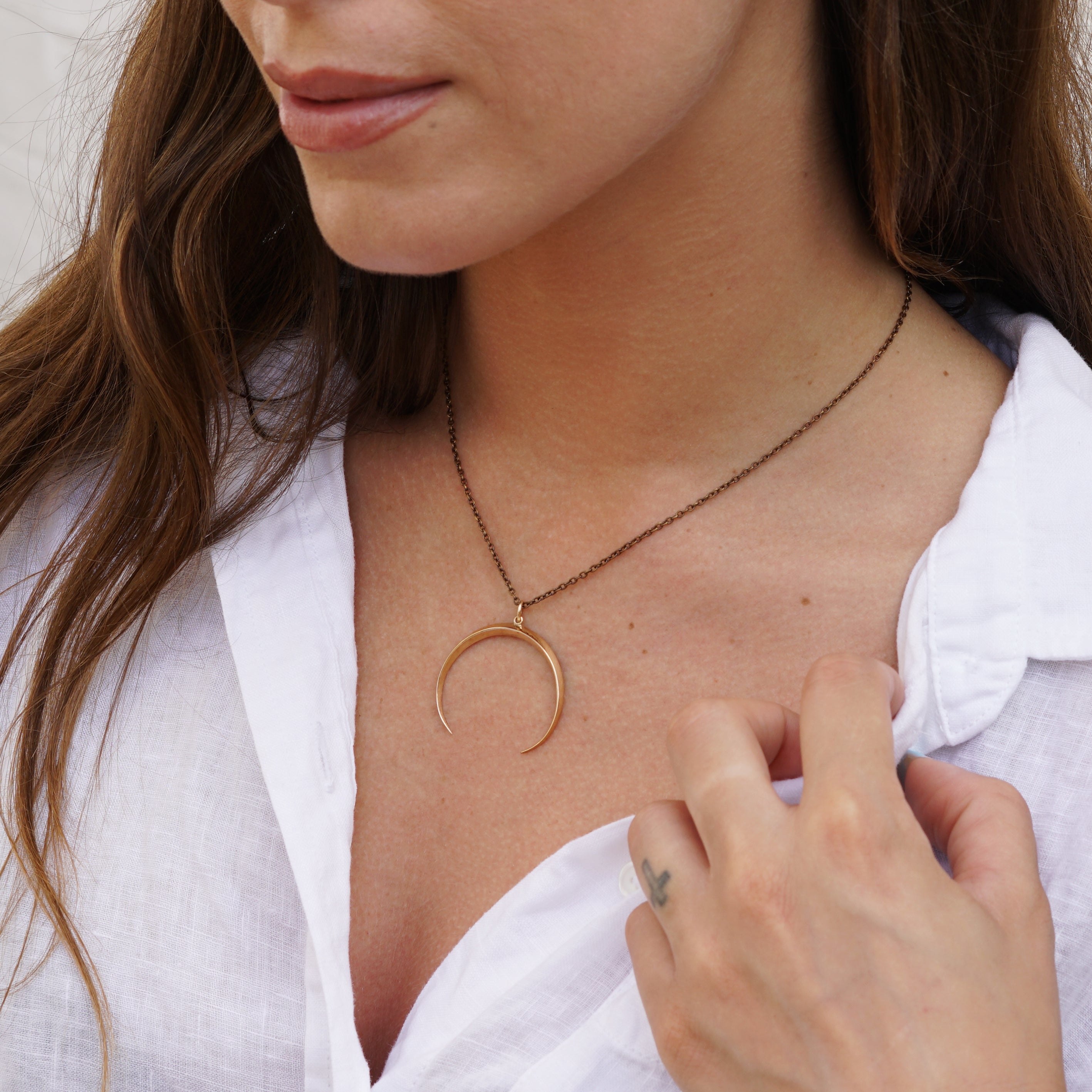 model wearing Crescent moon pendant necklace in bronze