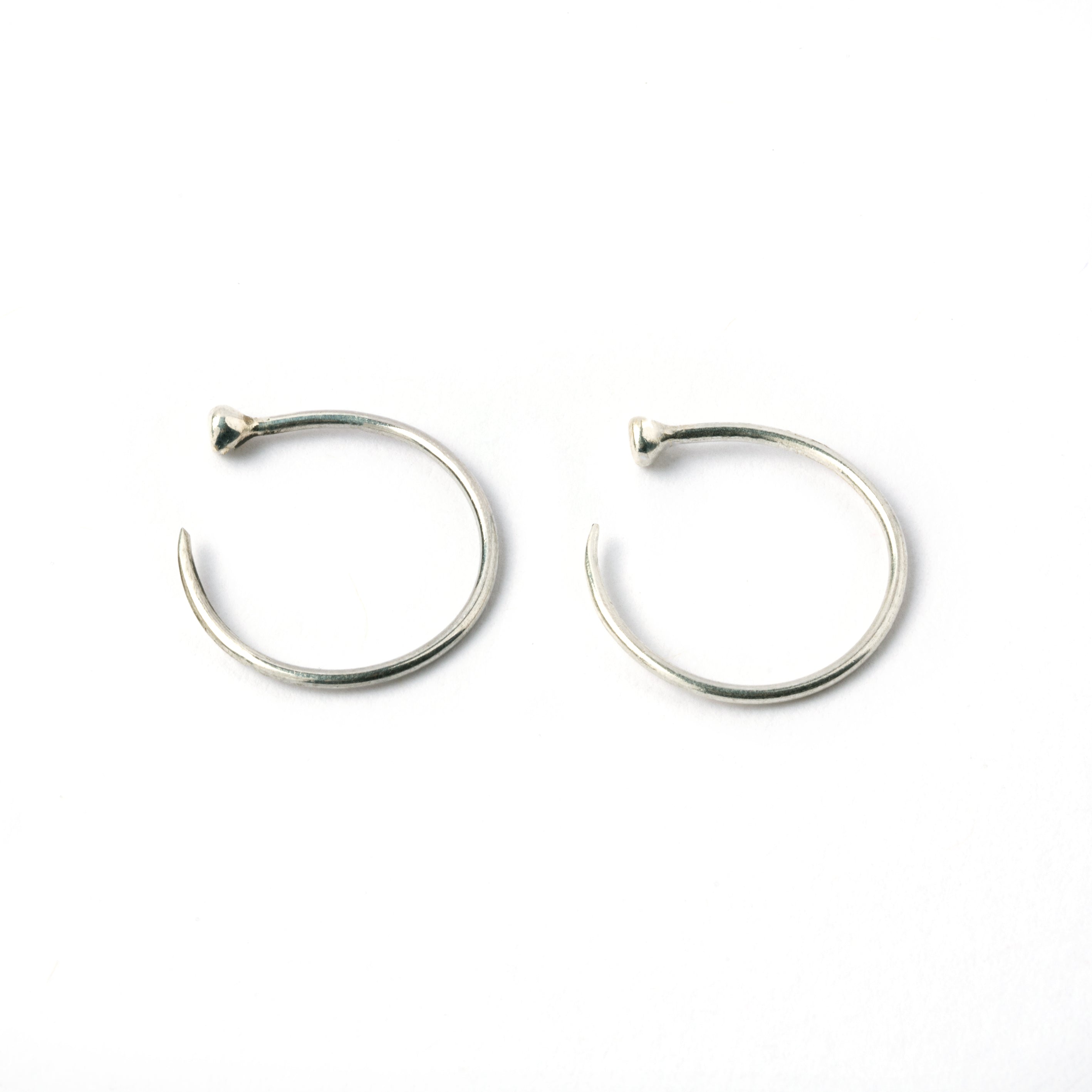 pair of open hoop silver wire earrings side view