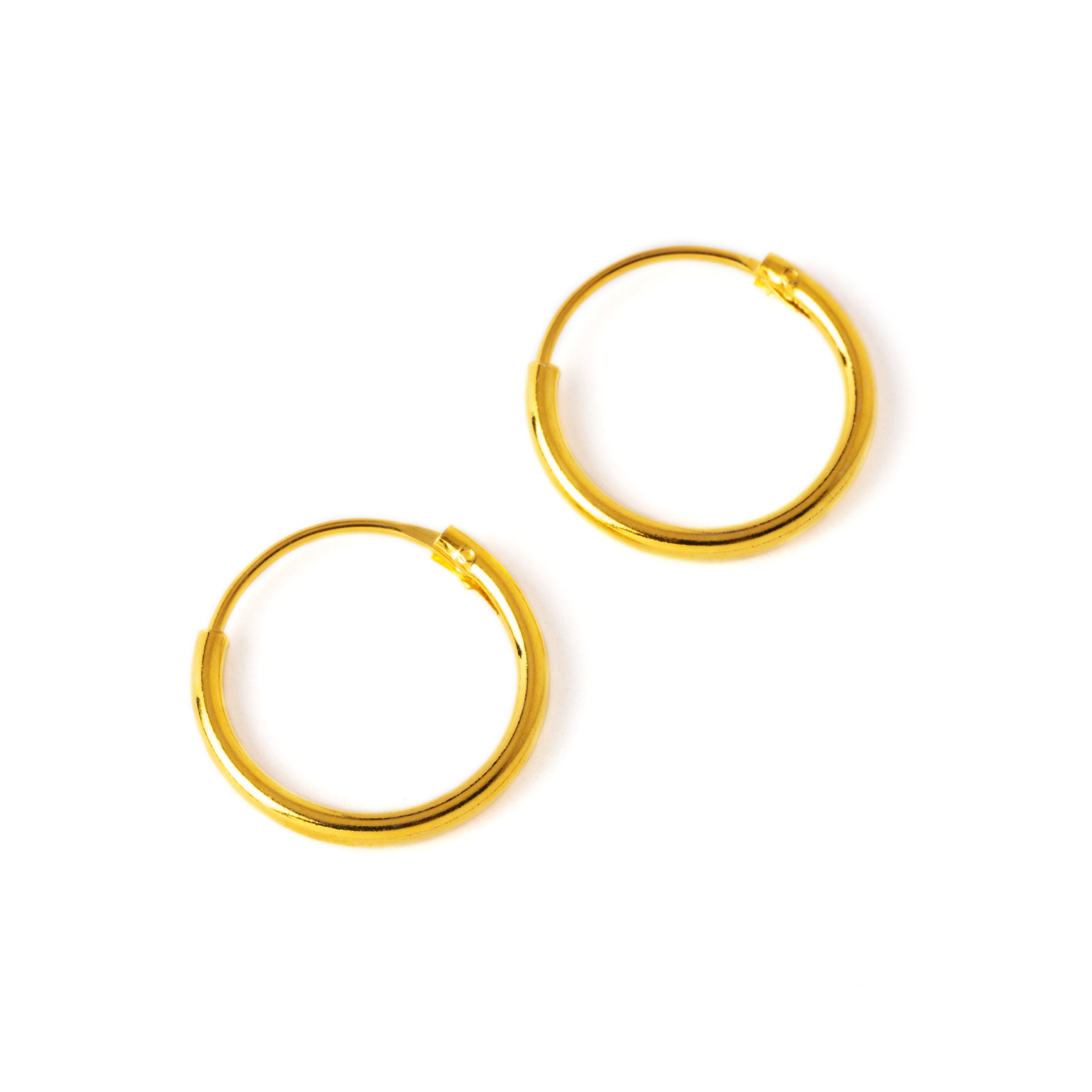 Gold thin hoop earrings left side view