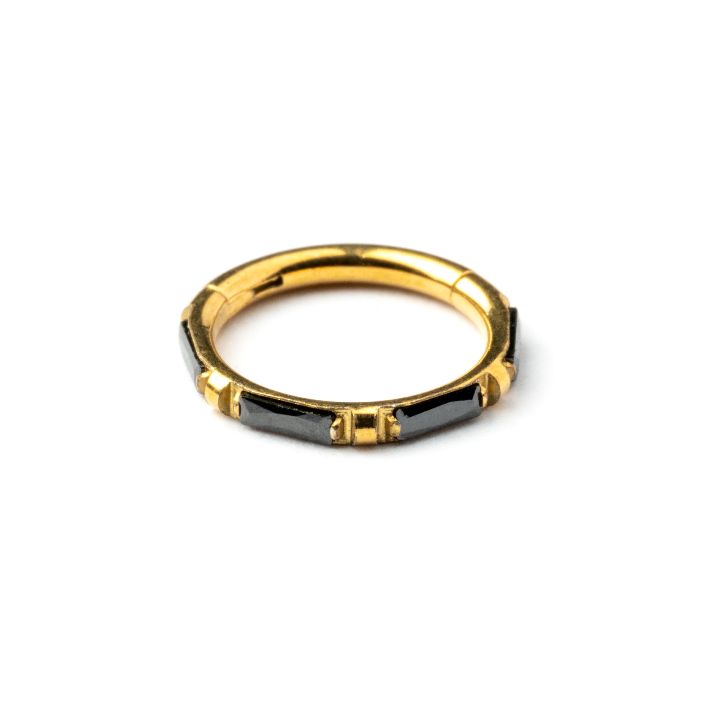 Gold septum clicker with black onyx stones around its rim frontal view