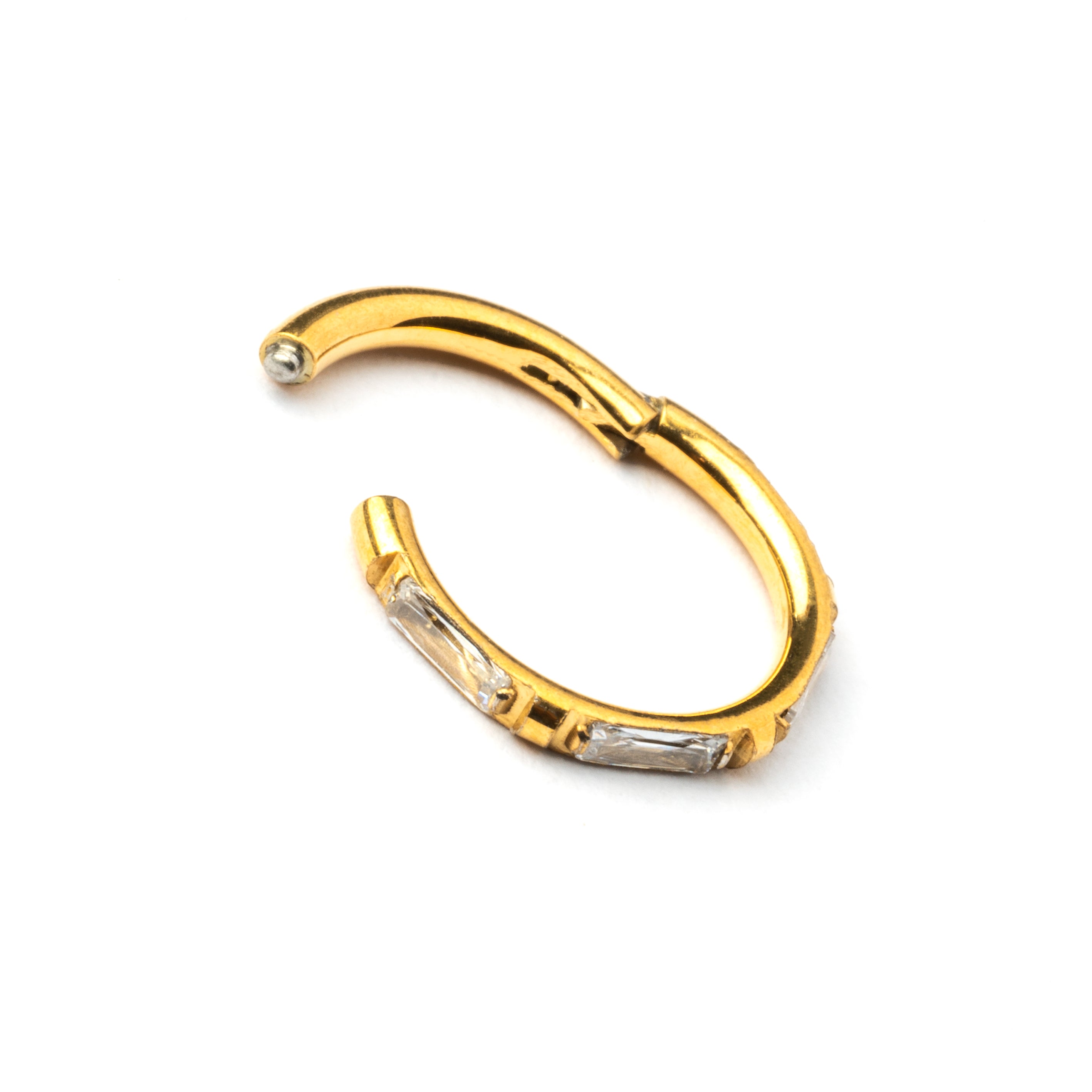 Gold septum clicker with crystal quartz around its rim closure view