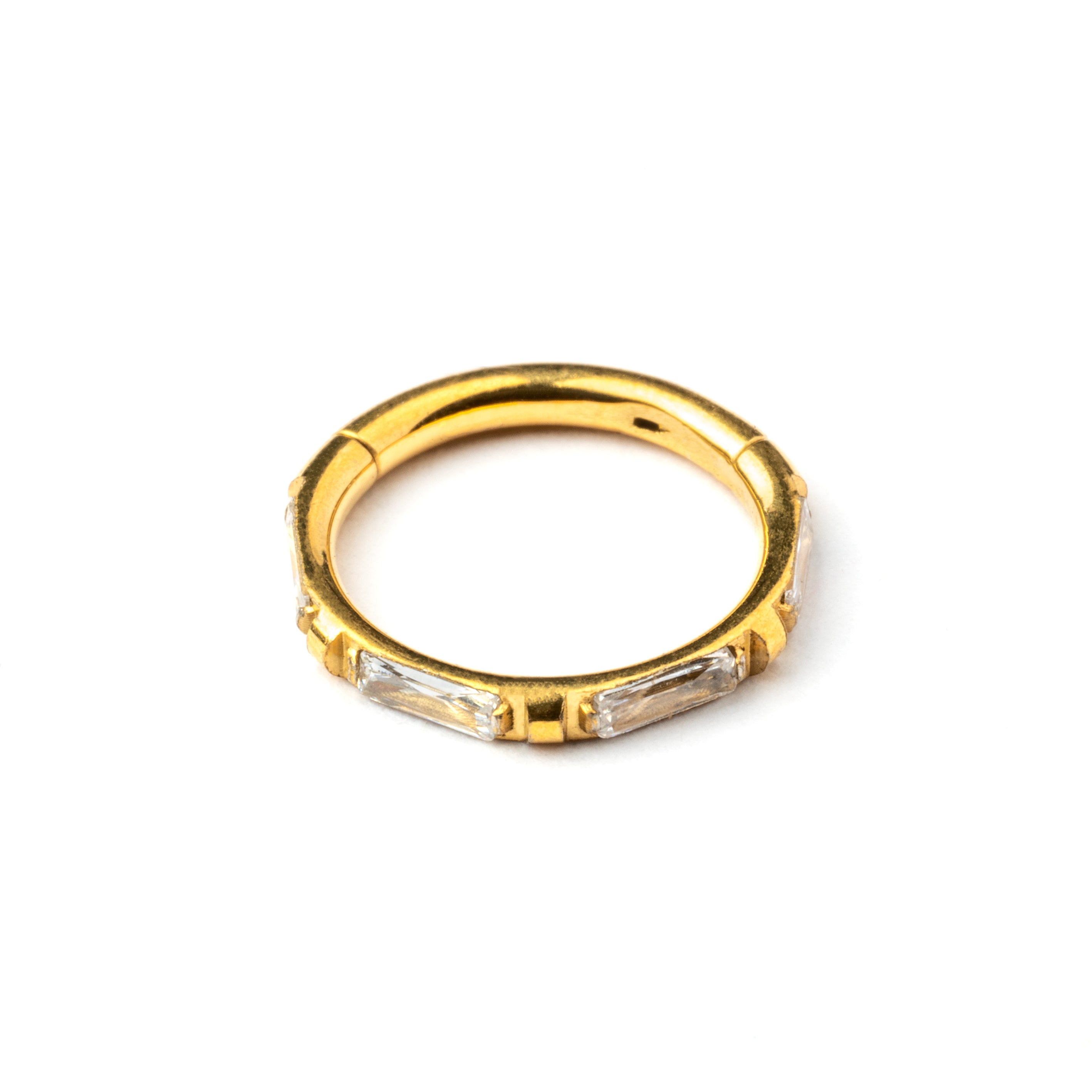 Gold septum clicker with crystal quartz around its rim frontal view
