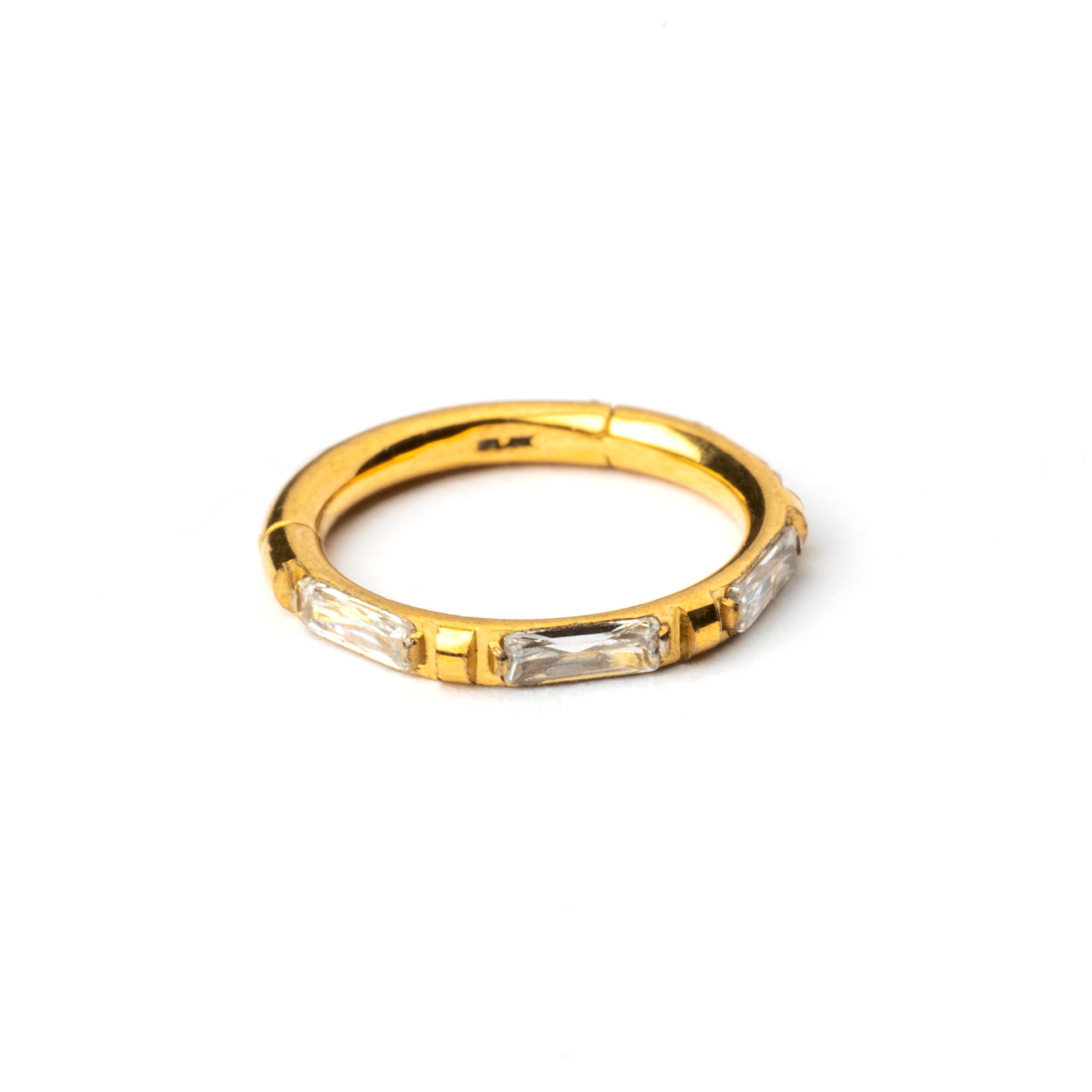 Gold septum clicker with crystal quartz around its rim frontal view