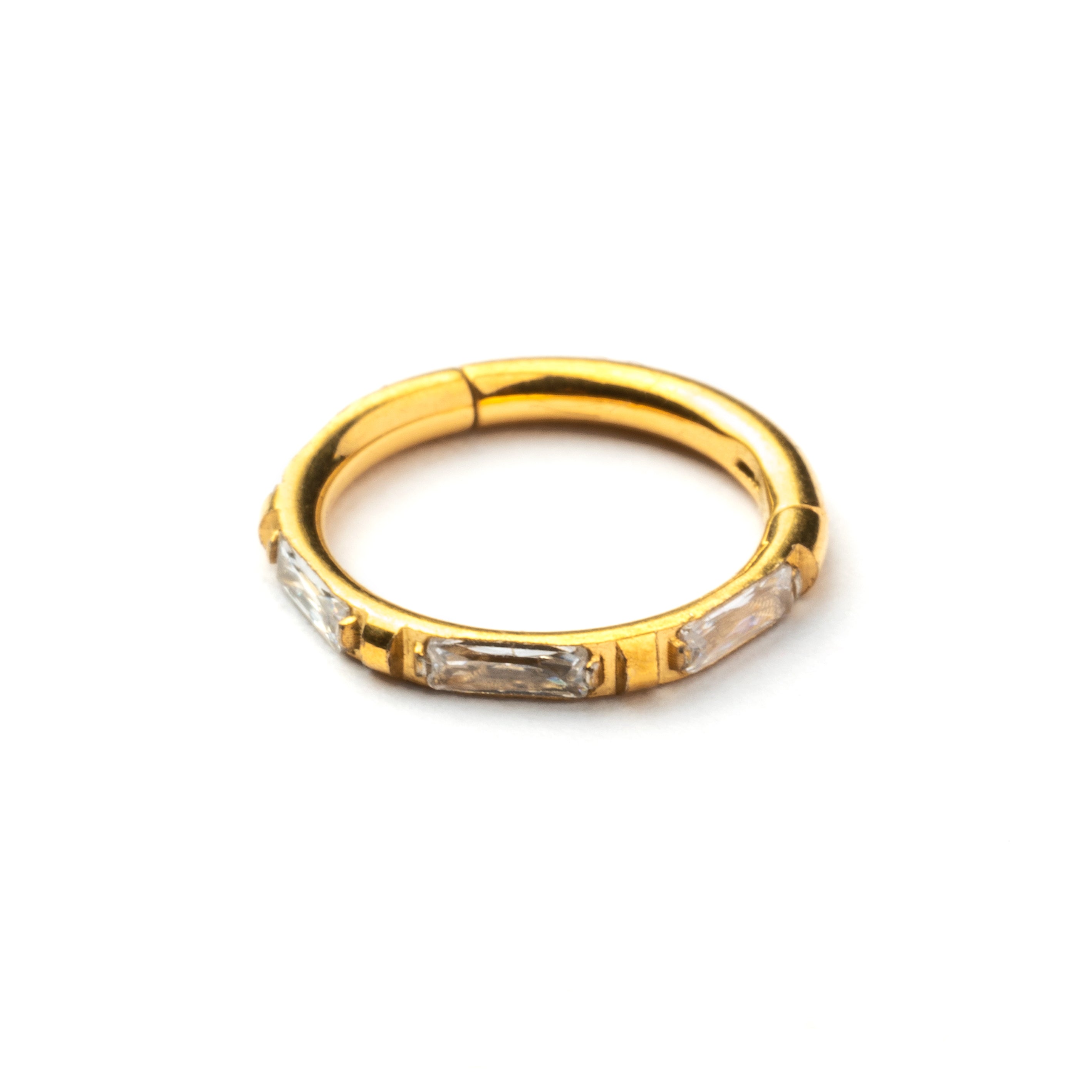 Gold septum clicker with crystal quartz around its rim frontal view