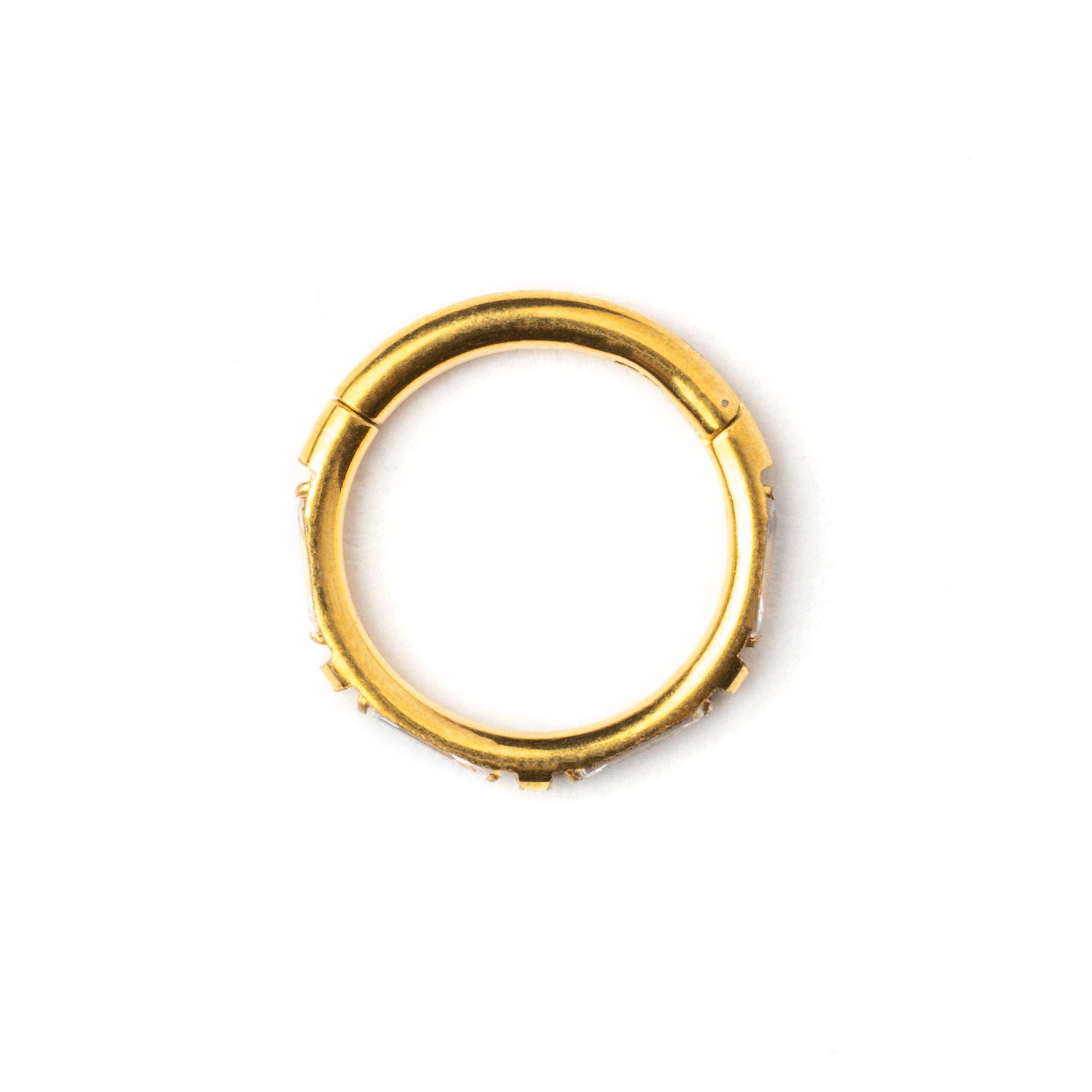 Gold septum clicker with crystal quartz around its rim side view