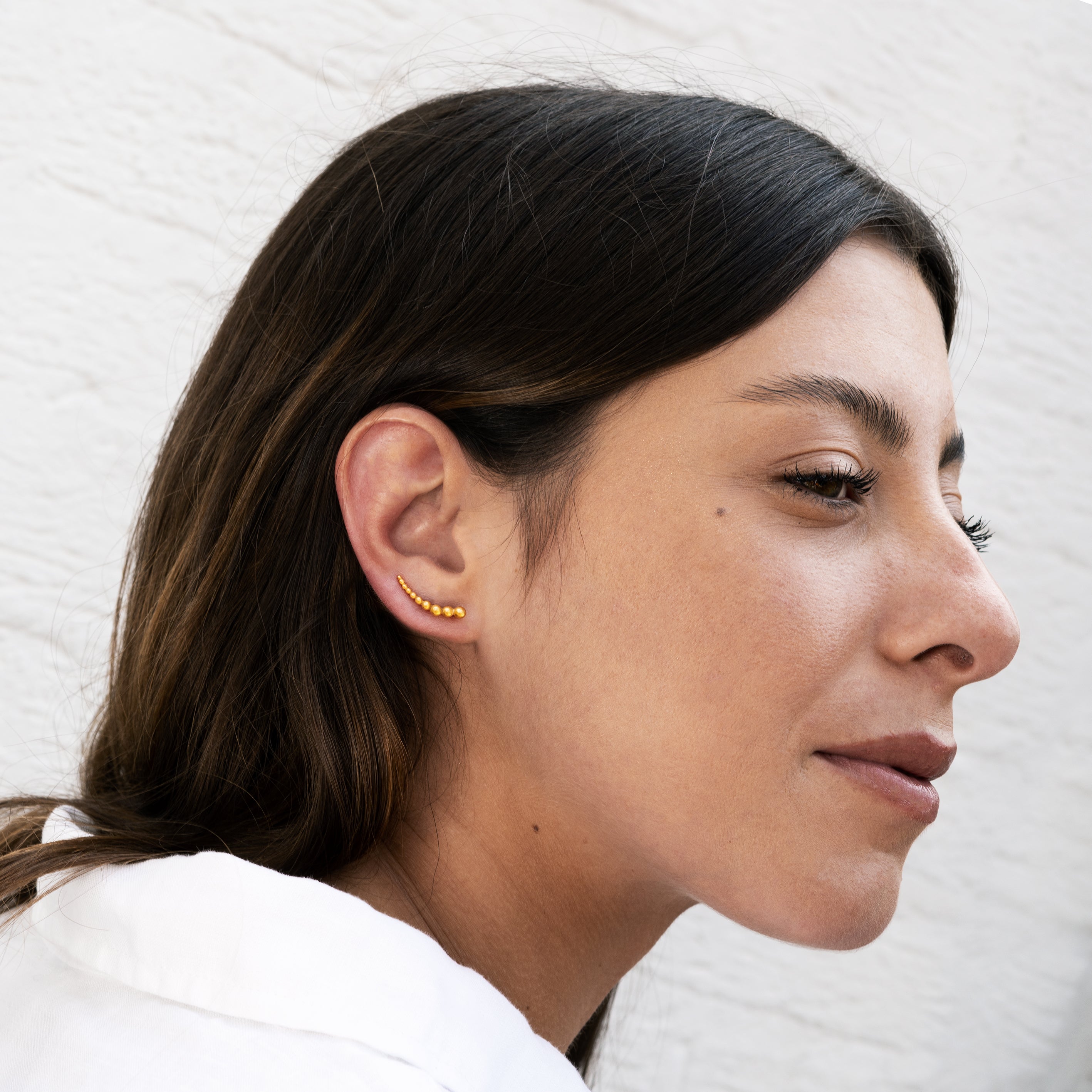 model wearing 24k gold plated silver multiple spheres ear climber1