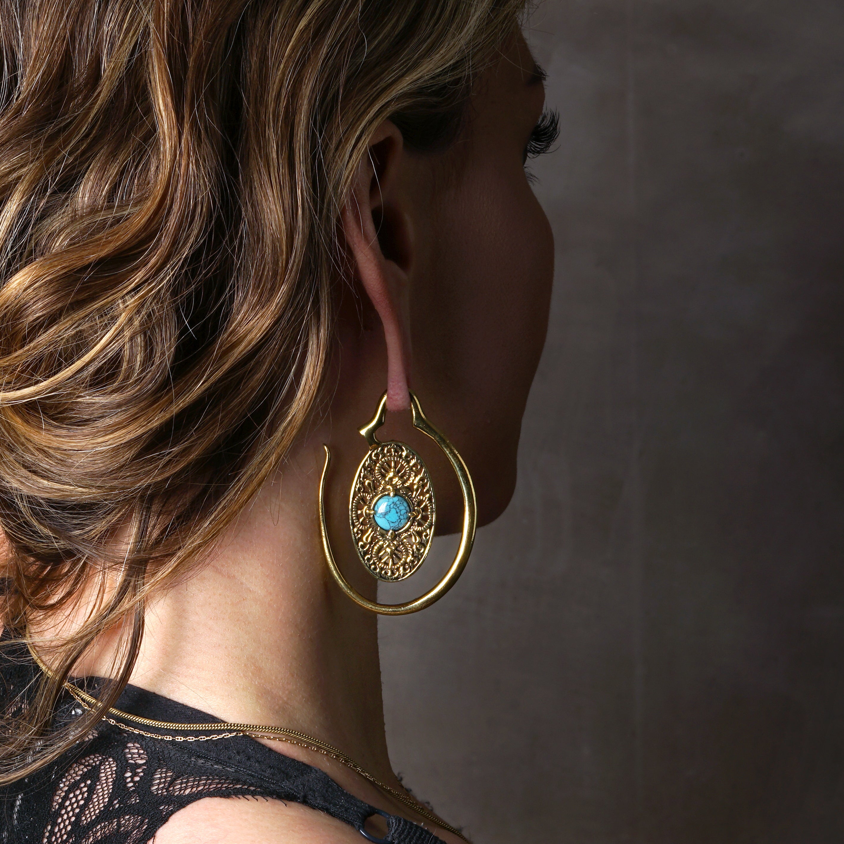 model wearing Golden Aurora Hangers with Turquoise