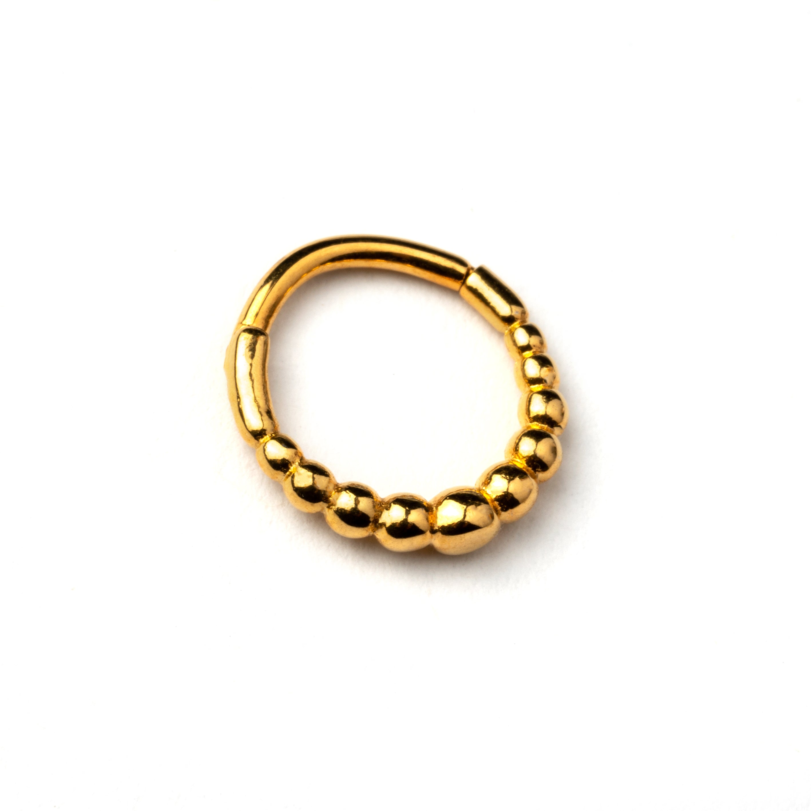 Golden surgical steel clicker piercing ring formed by tiny spheres side view