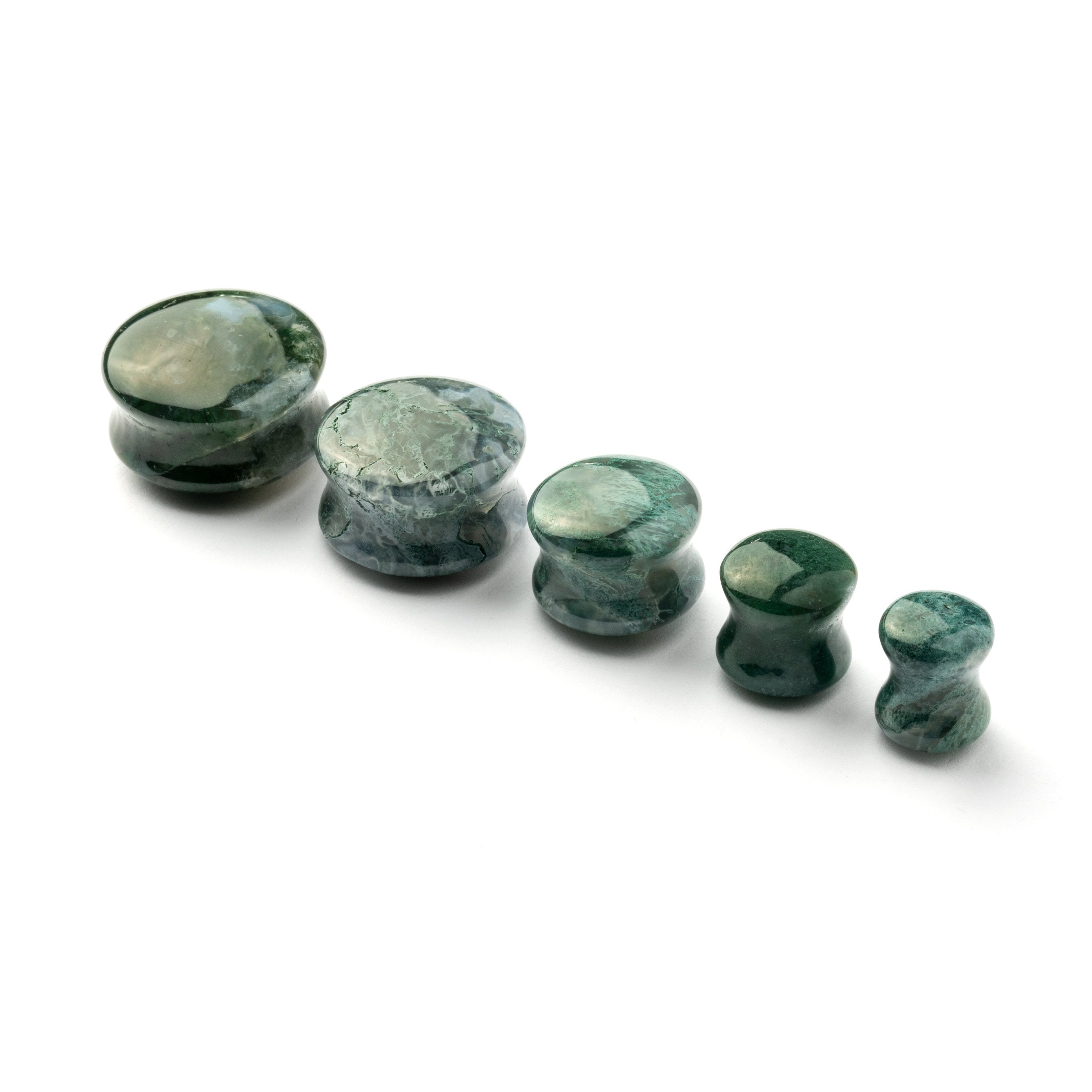 several sizes of African Green Jade double flare stone ear plugs side view