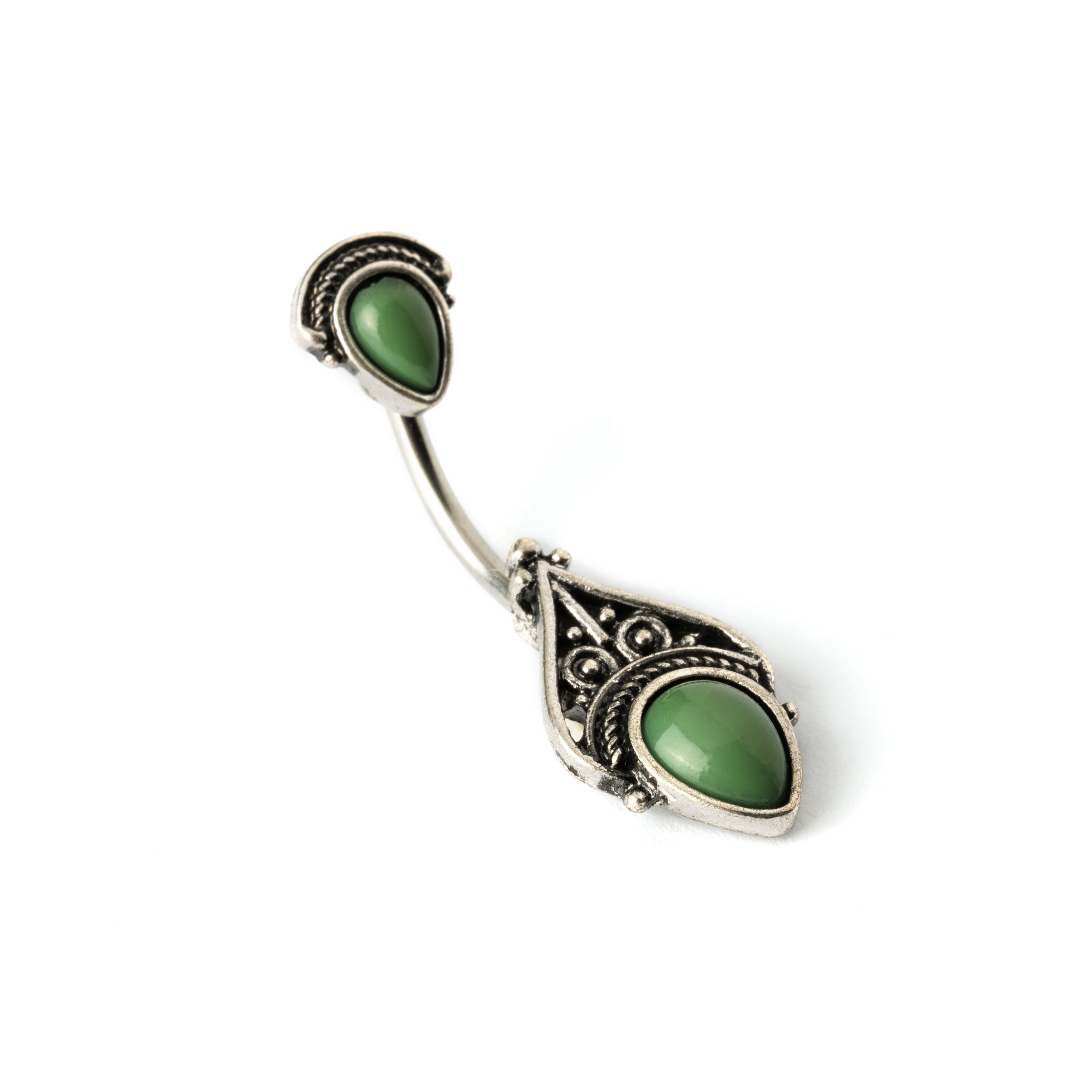 navel bar with silver toned goth ornament with two green stones one at the top and one at the bottom right side view