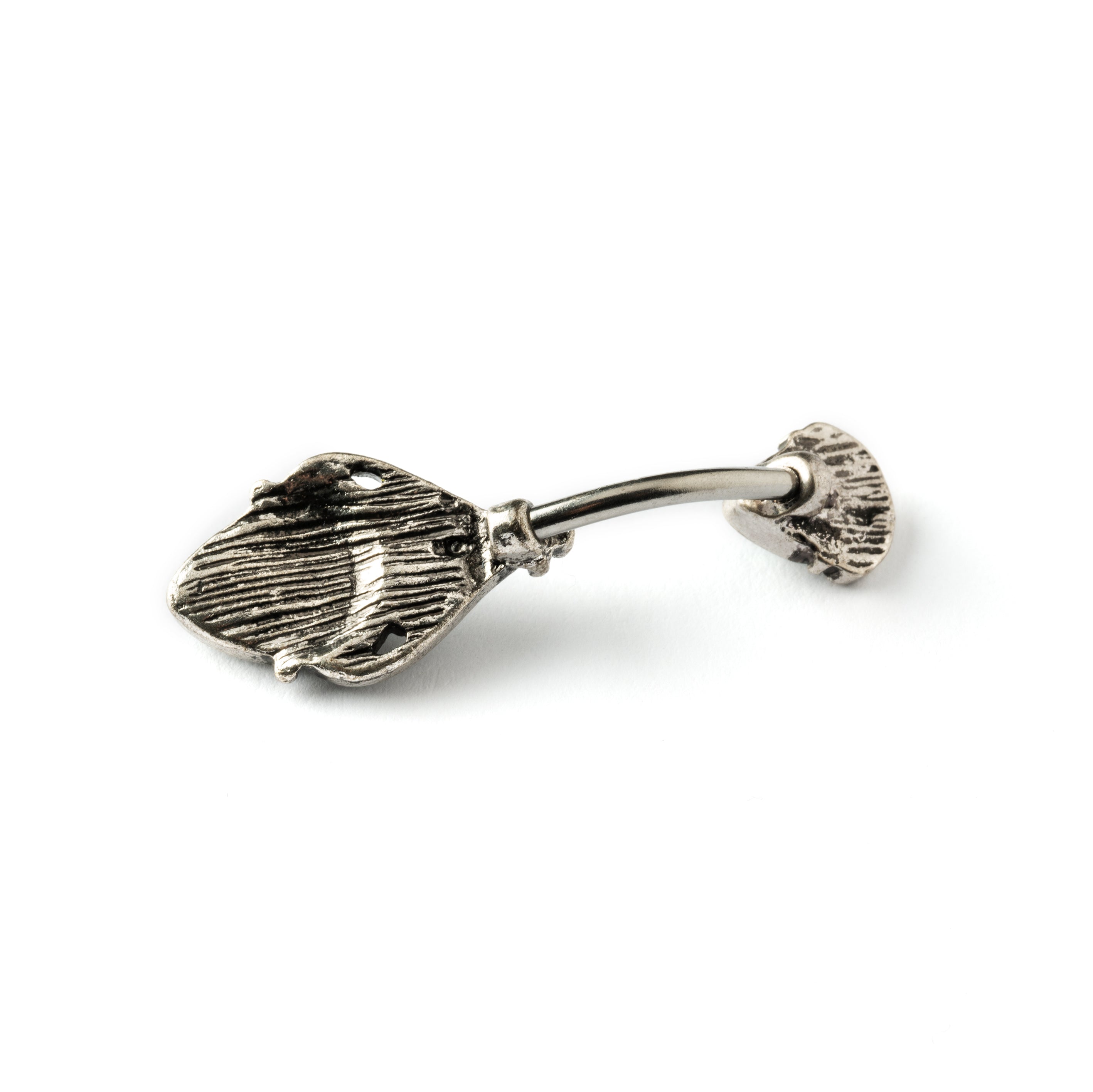 navel bar with silver toned goth ornament with two green stones one at the top and one at the bottom back view