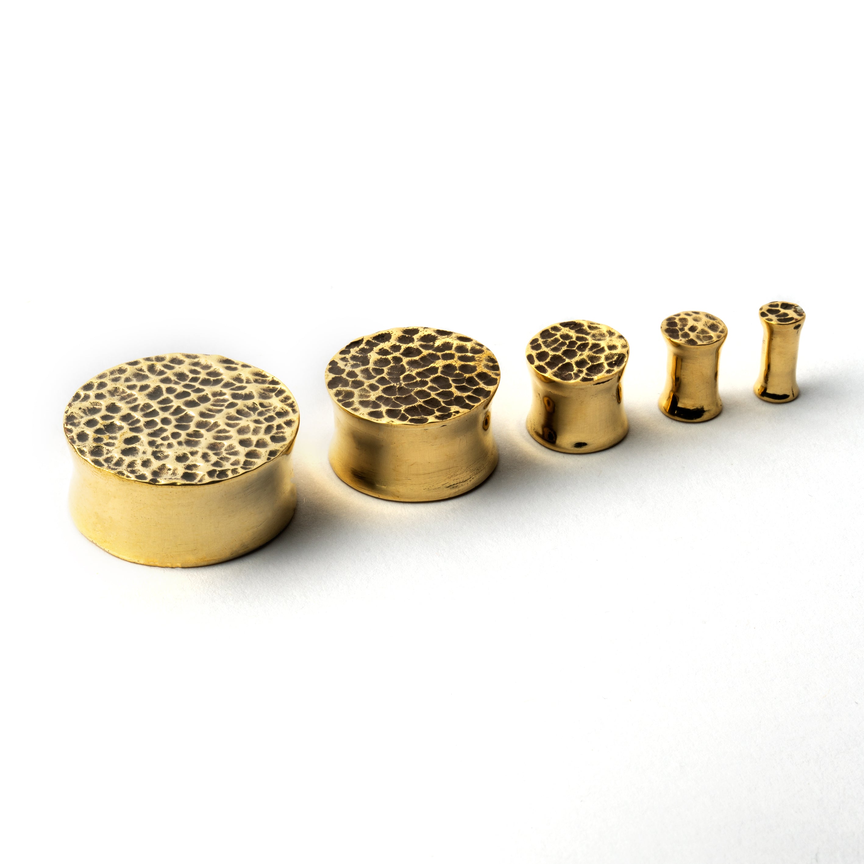 Hammered golden brass plug earrings different sizes shot
