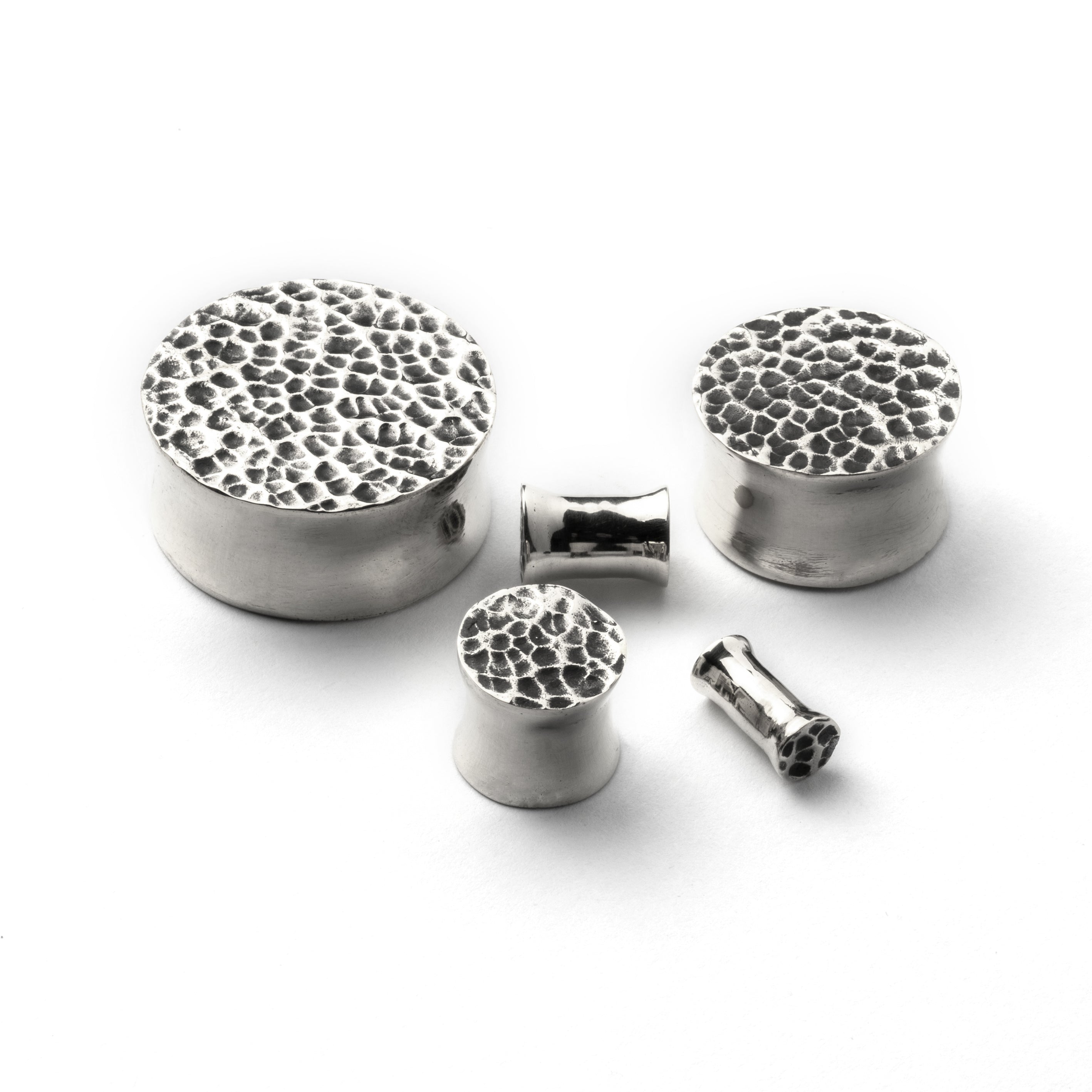 several sizes of hammered silver double flared ear plugs all view
