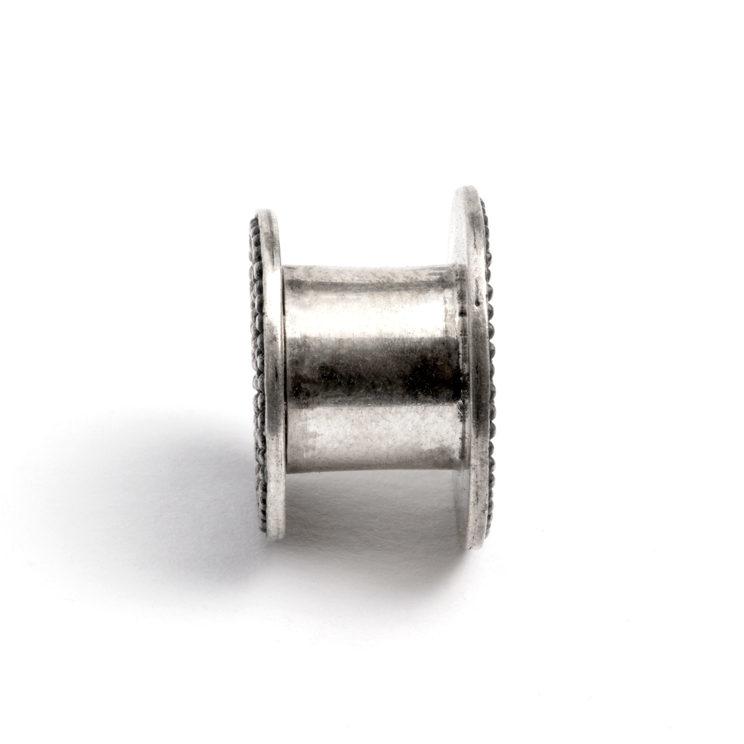 single tribal screw on silver plug tunnel ornamented with spheres side view