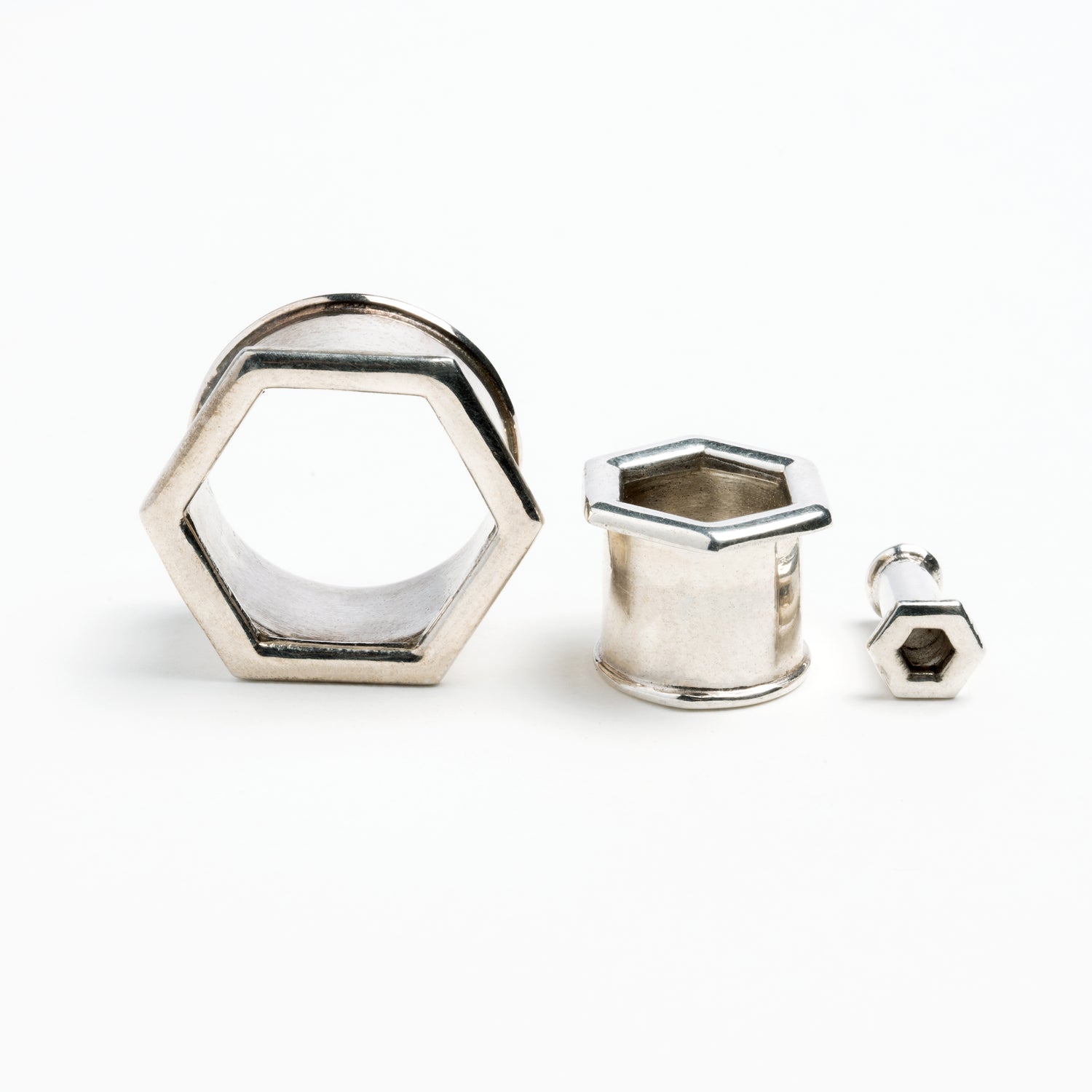 several sizes of hexagon ear tunnels front and side view