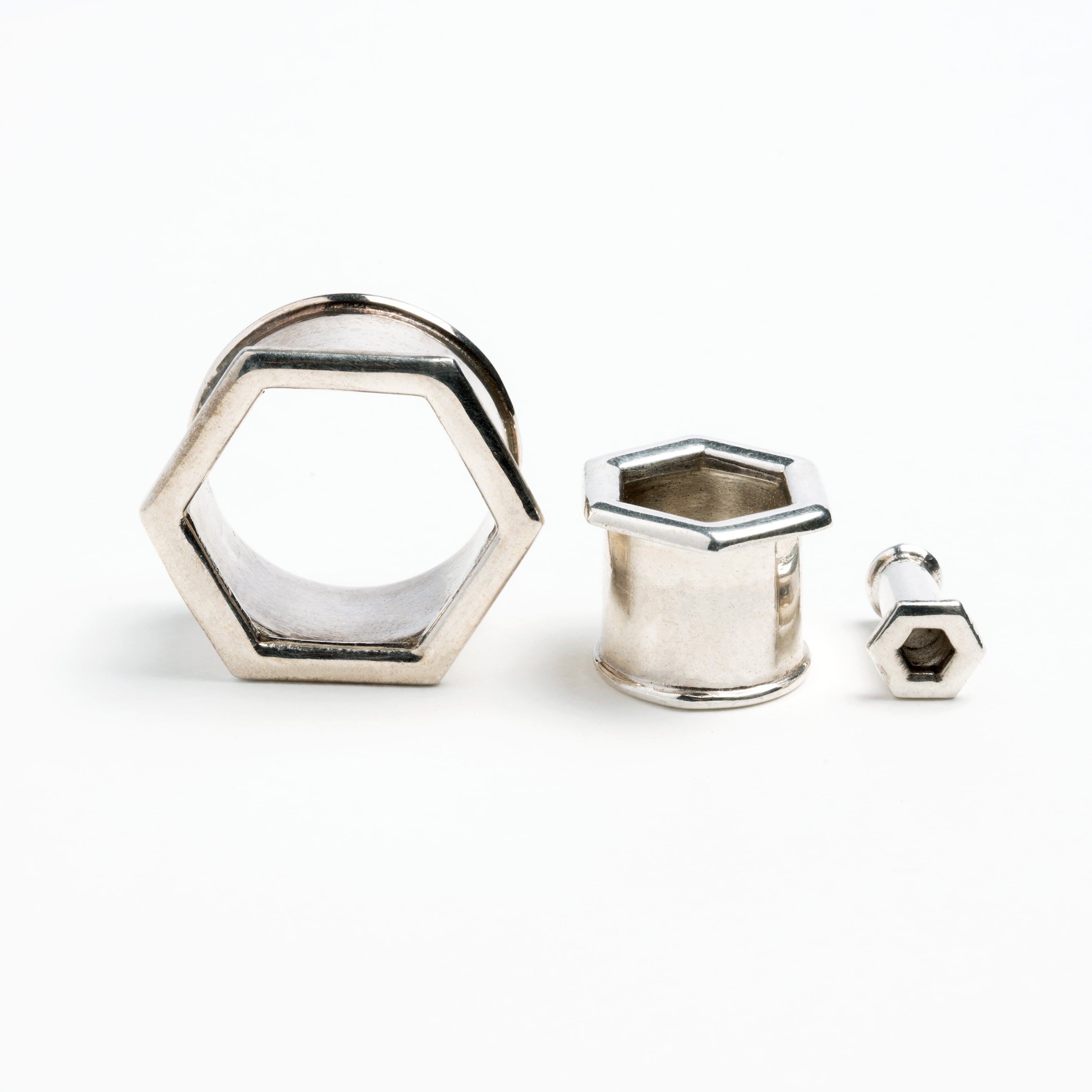 several sizes of hexagon ear tunnels front and side view