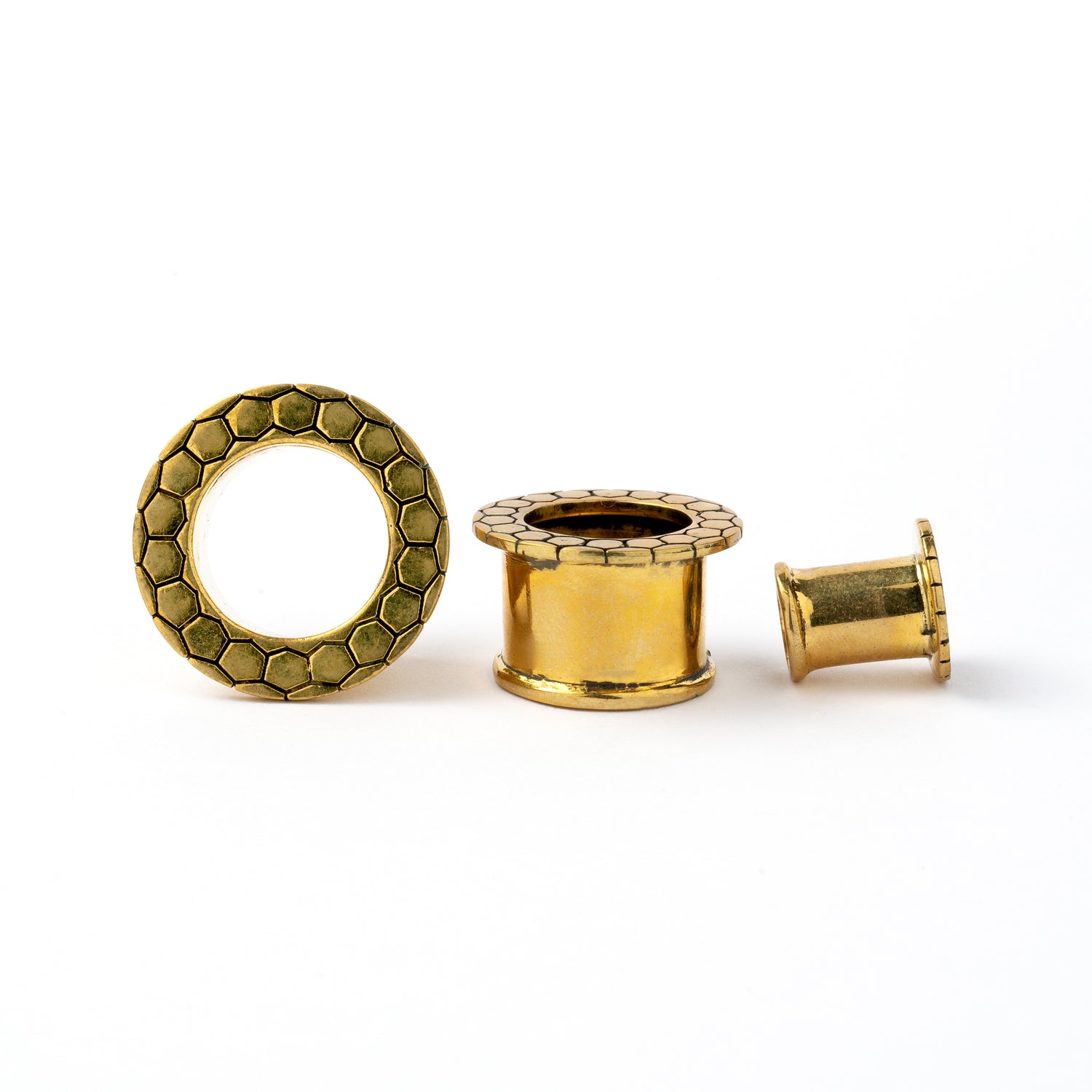 several sizes of Honeycomb golden brass flesh tunnels for stretched ears front and side view