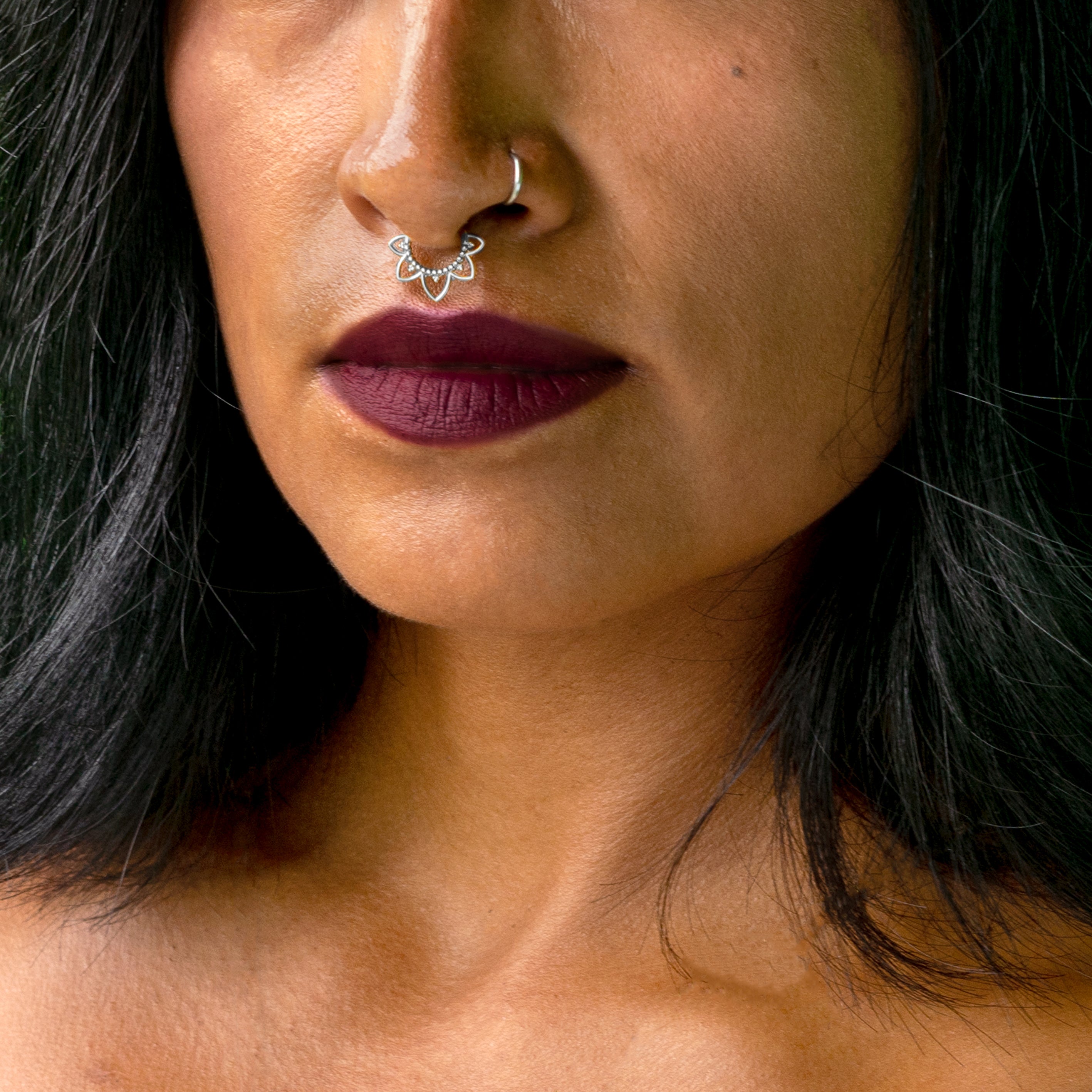 model wearing 1.2mm (16g), 8mm Iriya surgical steel lotus flower septum clicker frontal view